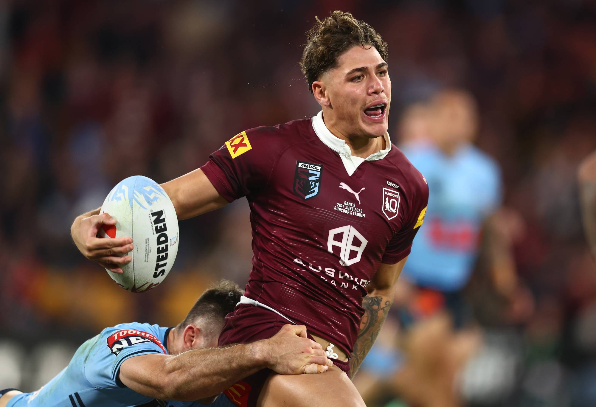 Reece Walsh of the Maroons is tackled during game two of the State of Origin series between the Queensland Maroons and the New South Wales Blues at Suncorp Stadium on June 21, 2023 in Brisbane, Australia. (Photo by Chris Hyde/Getty Images)