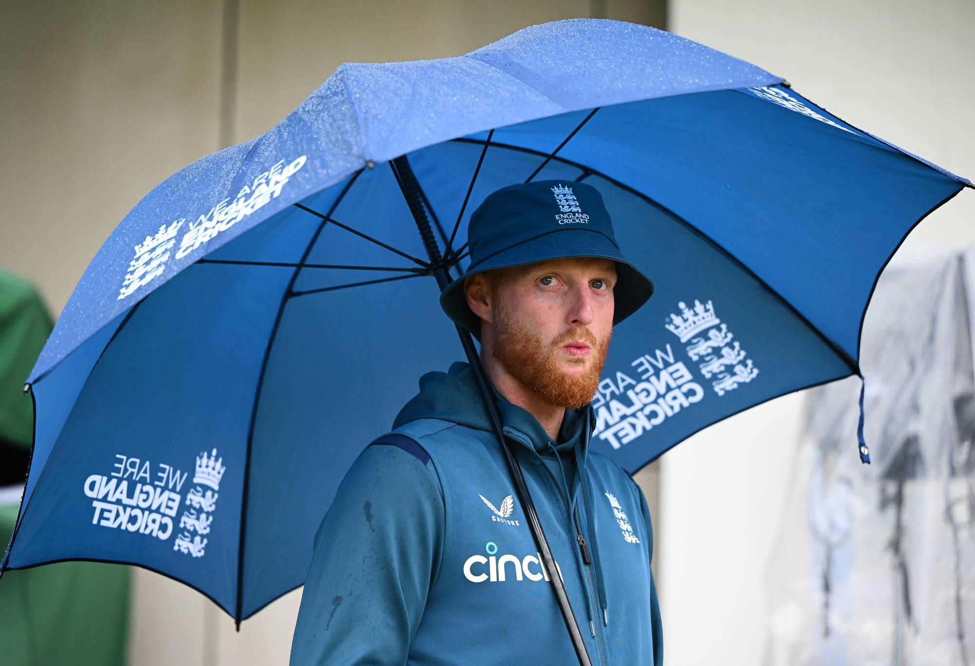 Ben Stokes of England looks on during the end of match presentations as he shelters from the rain on day five of the LV=Insurance Ashes 4th Test Match between England and Australia at Emirates Old Trafford on July 23, 2023 in Manchester, England. (Photo by Clive Mason/Getty Images)