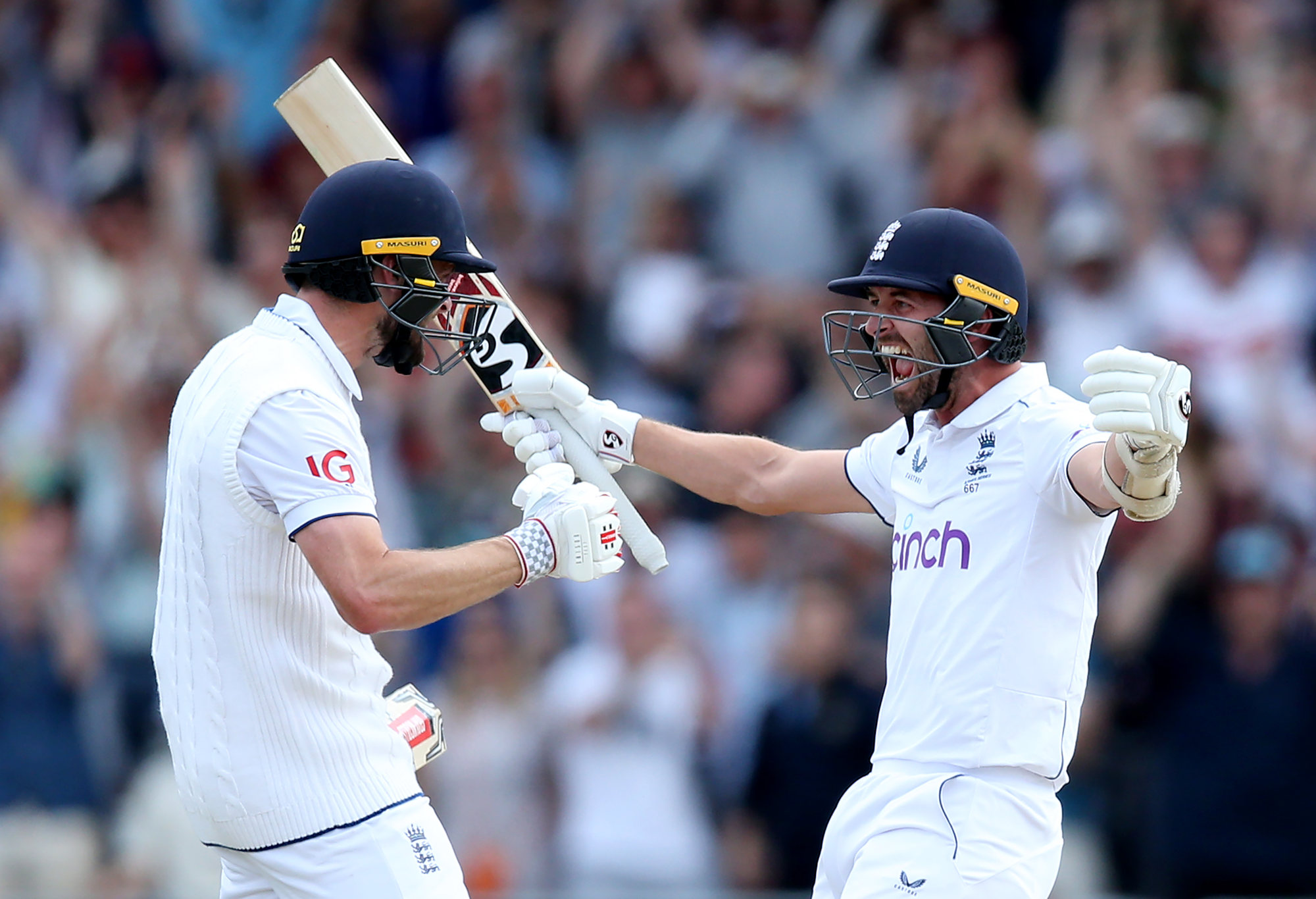 Chris Woakes celebrates with Mark Wood after hitting the winning runs.