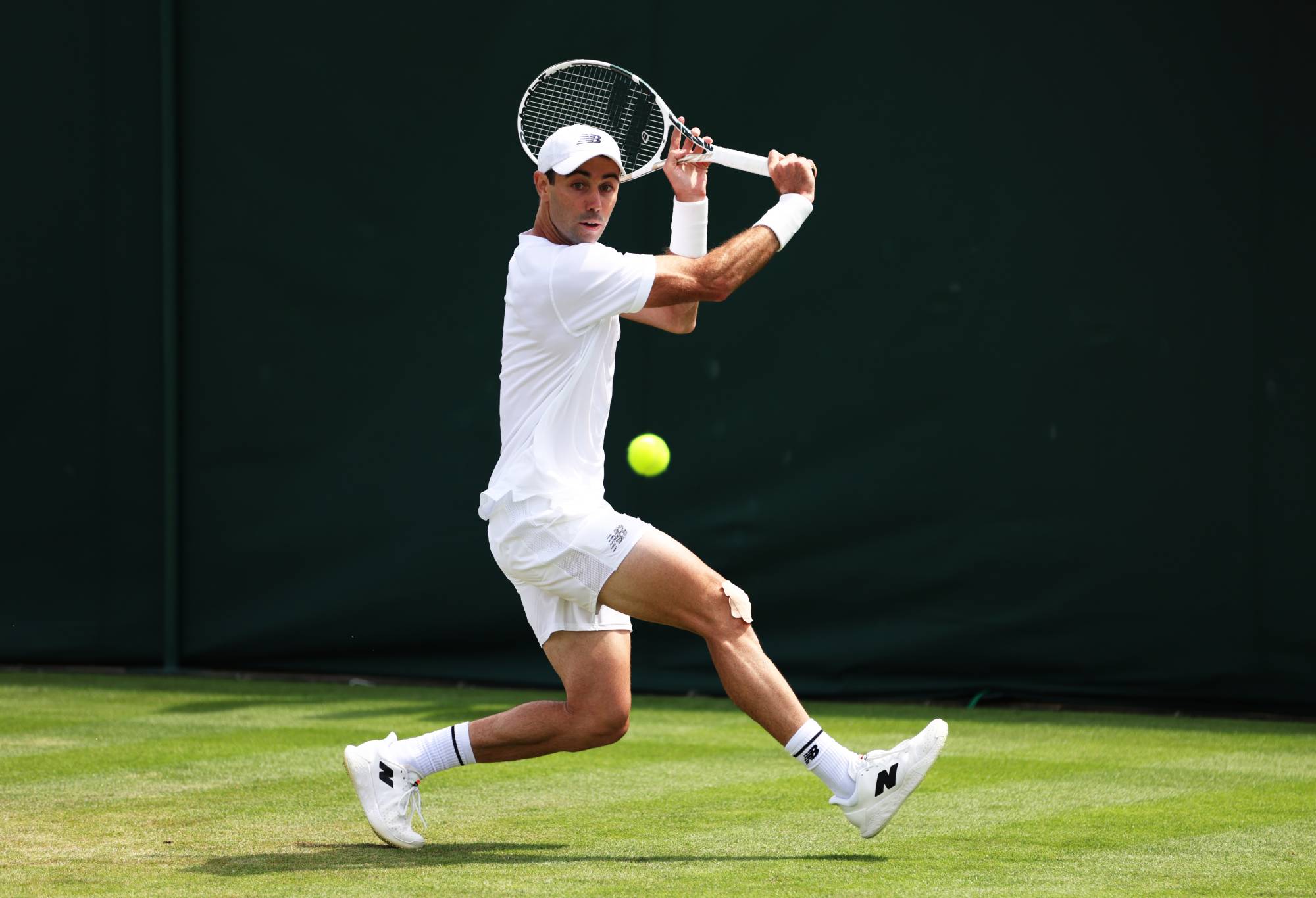 LONDON, ENGLAND - JULY 03: Jordan Thompson of Australia plays a backhand against Brandon Nakashima of United States in the Men's Singles first round match on day one of The Championships Wimbledon 2023 at All England Lawn Tennis and Croquet Club on July 03, 2023 in London, England. (Photo by Clive Brunskill/Getty Images)