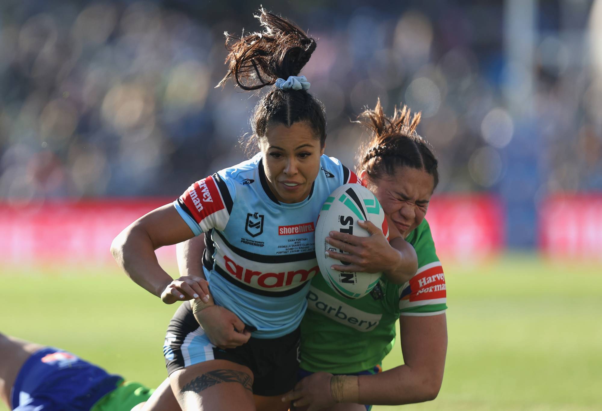 SYDNEY, AUSTRALIA - JULY 23: Tiana Penitani of the Cronulla Sharks is tackled during the round one NRLW match between Cronulla Sharks and Canberra Raiders at PointsBet Stadium, on July 23, 2023, in Sydney, Australia. (Photo by Tim Allsop/Getty Images)