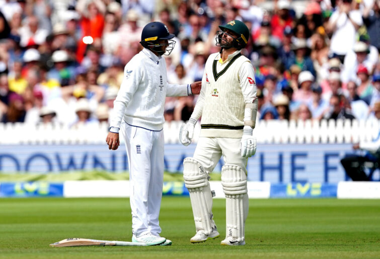 Nathan Lyon is checked on by Joe Root.