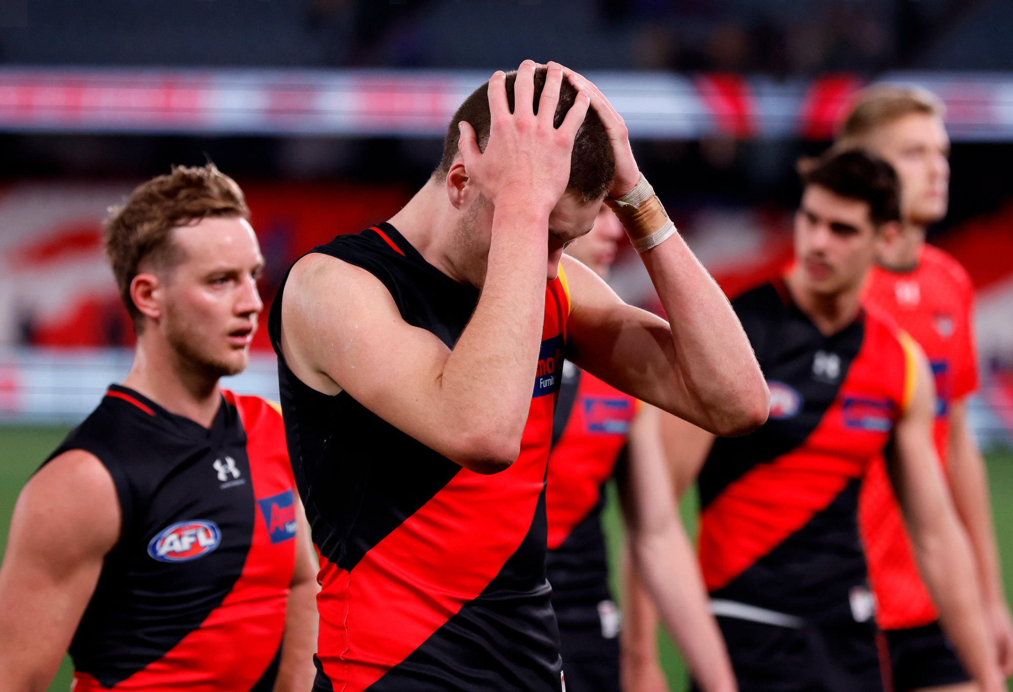 Essendon players react to their loss to the Western Bulldogs.