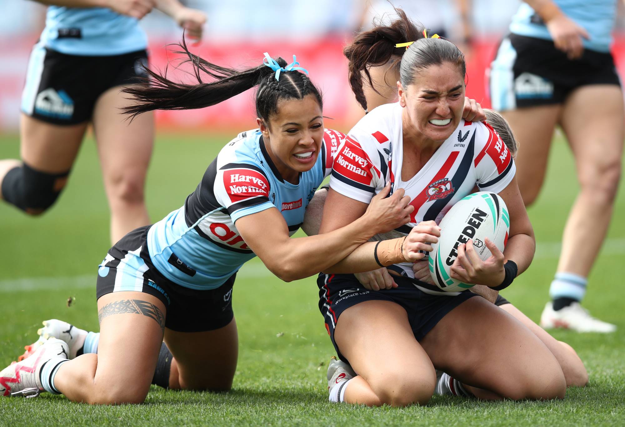 SYDNEY, AUSTRALIA - AUGUST 13: Olivia Kernick of the Roosters is tackled during the round four NRLW match between Cronulla Sharks and Sydney Roosters at PointsBet Stadium on August 13, 2023 in Sydney, Australia. (Photo by Jason McCawley/Getty Images)