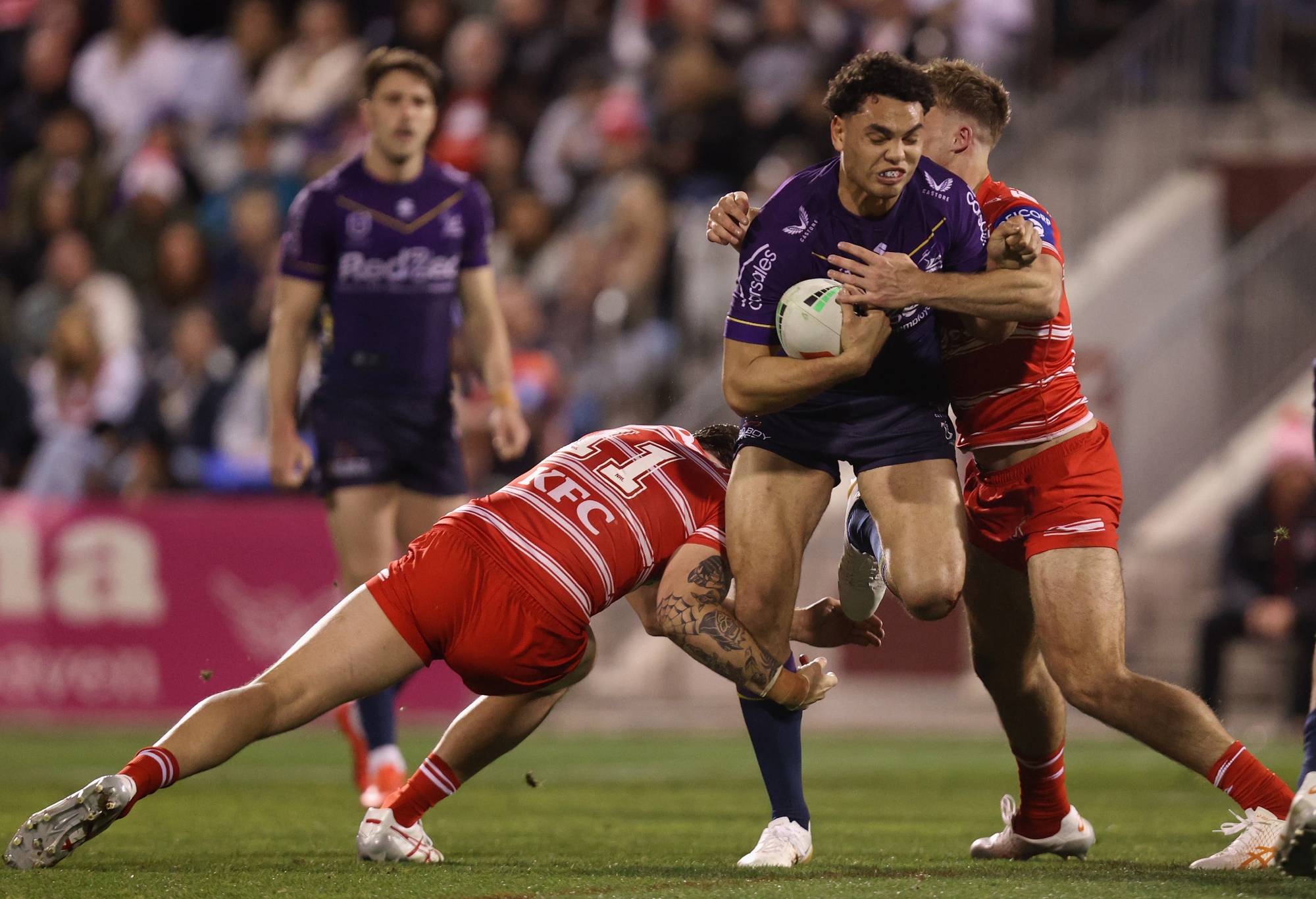 WOLLONGONG, AUSTRALIA - AUGUST 19: Xavier Coates of the Melbourne Storm breaks out of a tackle before scoring a try during the round 25 NRL match between St George Illawarra Dragons and Melbourne Storm at WIN Stadium on August 19, 2023 in Wollongong, Australia. (Photo by Tim Allsop/Getty Images)