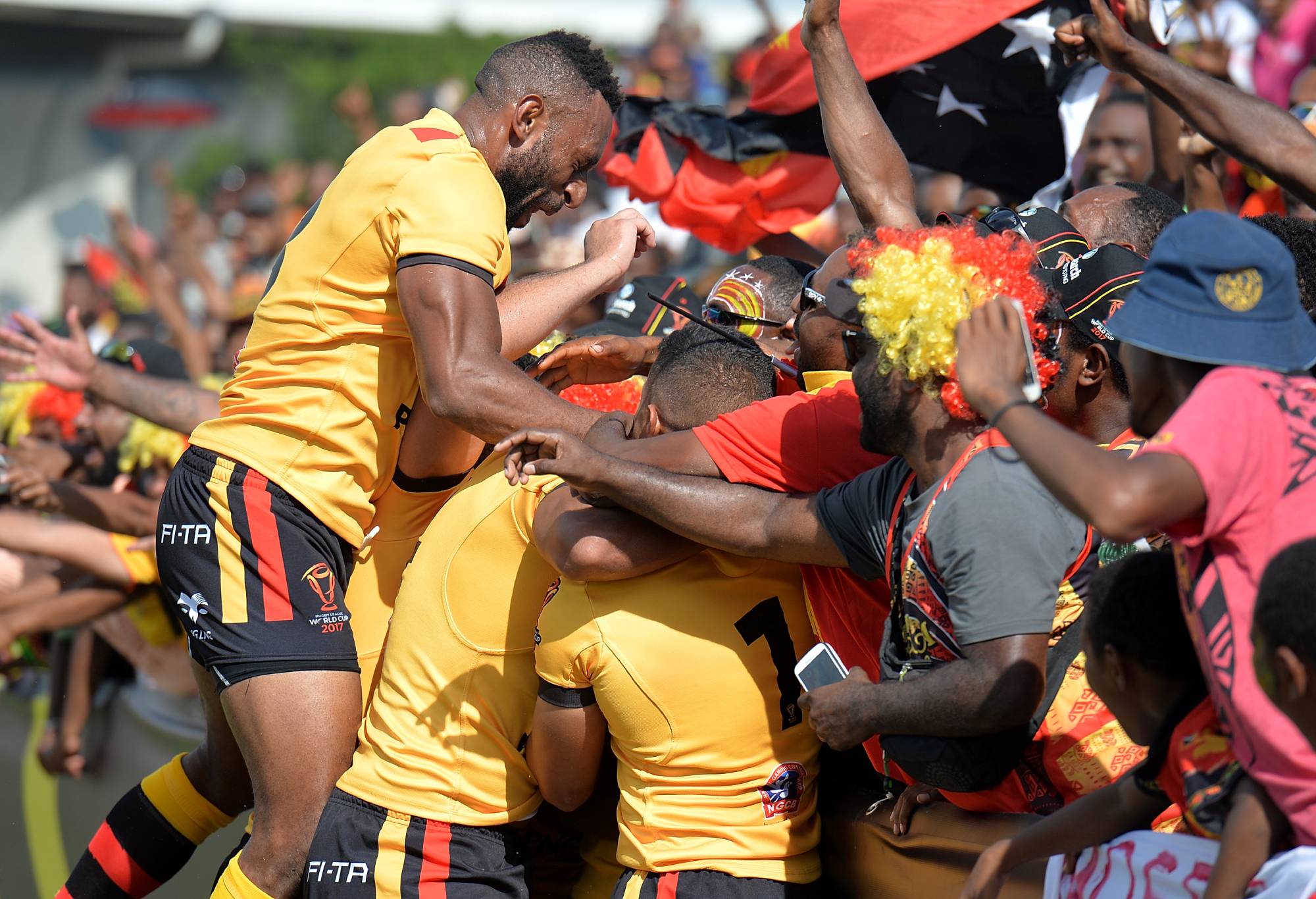 PORT MORESBY, PAPUA NEW GUINEA - NOVEMBER 12: Lachlan Lam of Papua New Guinea is congratulated by team mates after scoring a try during the 2017 Rugby League World Cup match between Papua New Guinea and the United States on November 12, 2017 in Port Moresby, Papua New Guinea.  (Photo by Bradley Kanaris/Getty Images)