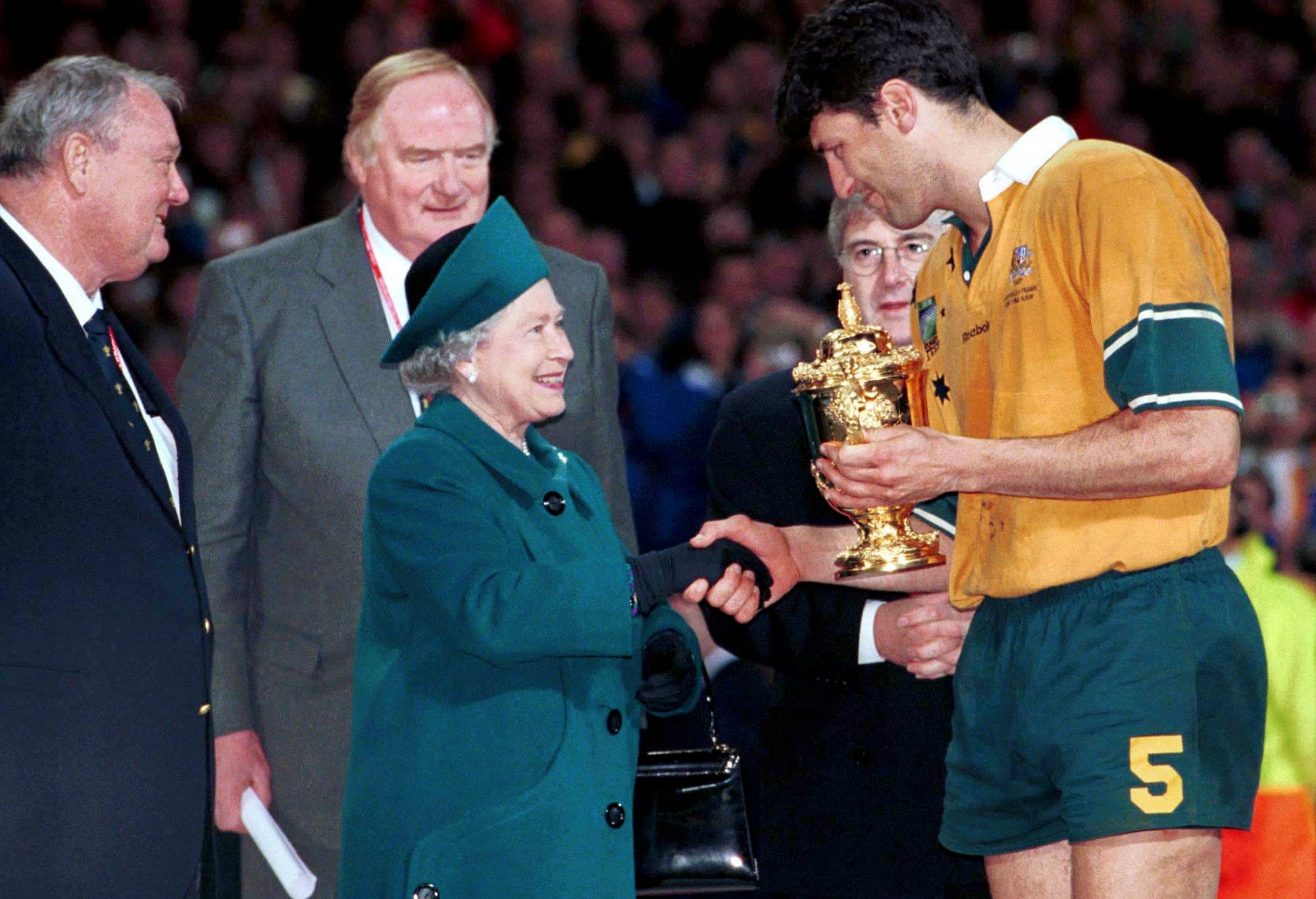  John Eales, Australian captain, receives the Webb Ellis trophy from HRH Queen Elizabeth after his side defeated France. 1999 Rugby World Cup, Australia v France, Millennium Stadium, Cardiff, Wales. Picture credit: Brendan Moran / SPORTSFILE (Photo by Sportsfile/Corbis/Sportsfile via Getty Images)