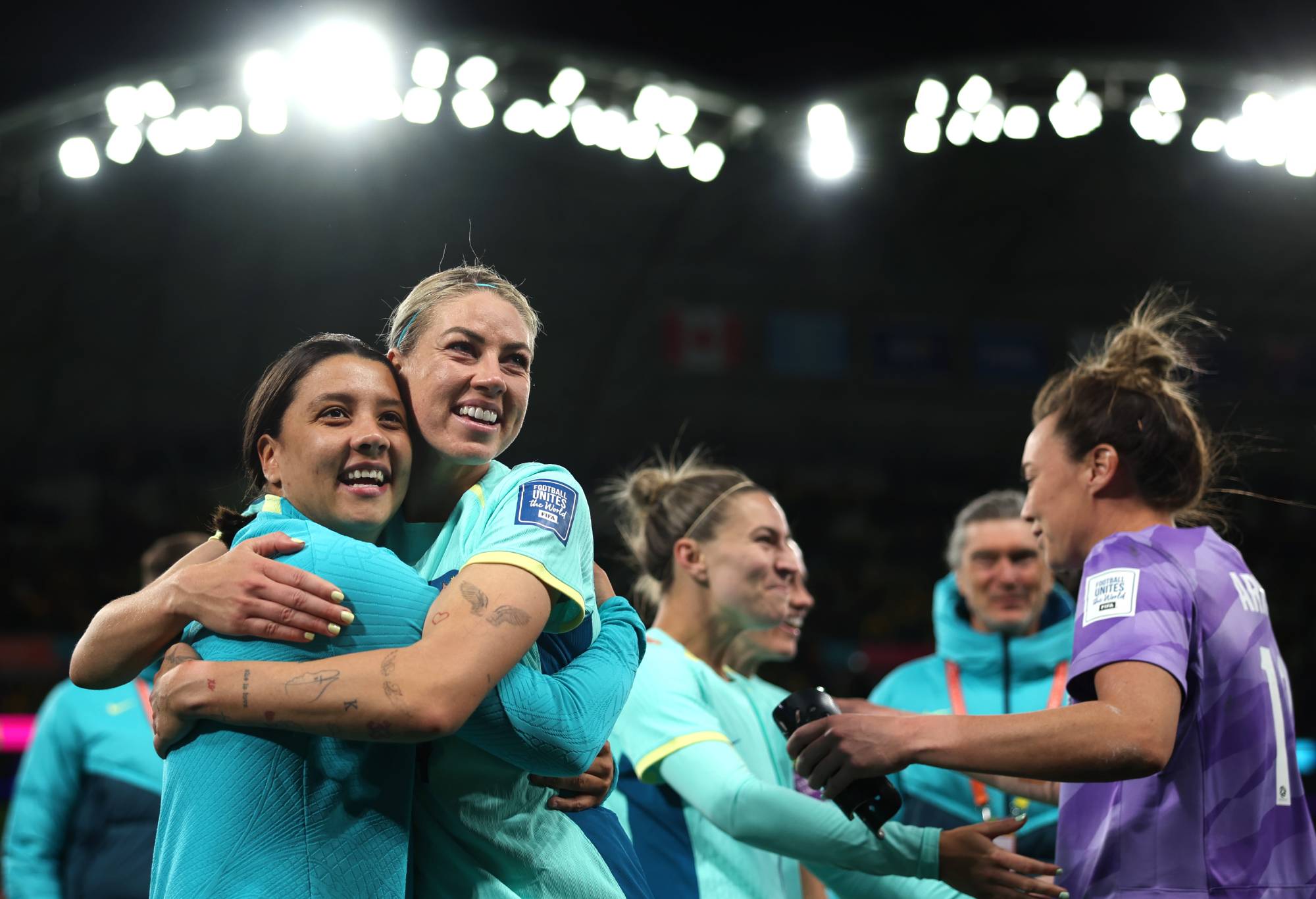 Sam Kerr and Alanna Kennedy of Australia celebrate the team's 4-0 victory and qualification for the knockout stage following the FIFA Women's World Cup Australia & New Zealand 2023 Group B match between Canada and Australia at Melbourne Rectangular Stadium on July 31, 2023 in Melbourne / Naarm, Australia. (Photo by Alex Pantling - FIFA/FIFA via Getty Images)