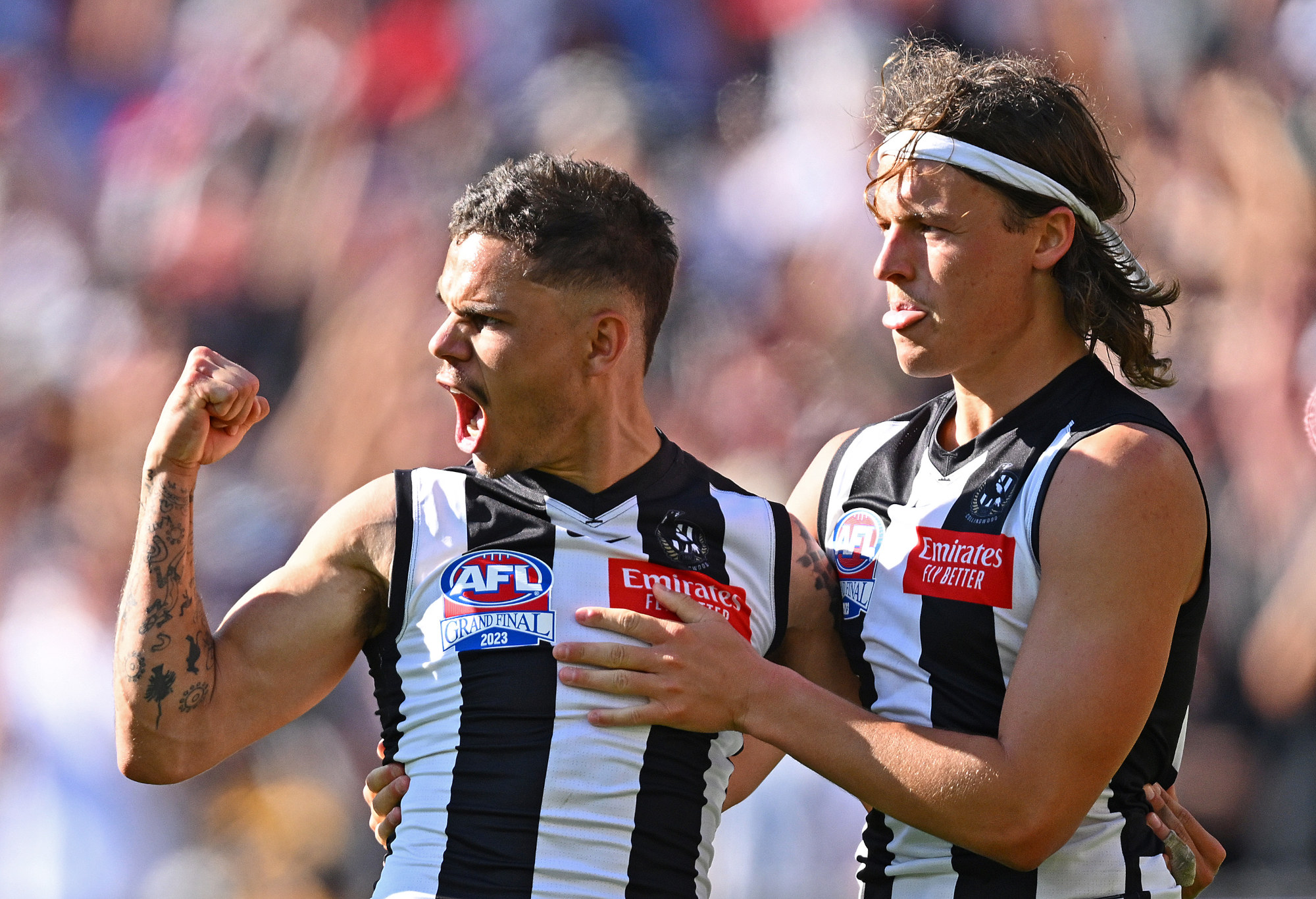 Bobby Hill and Jack Ginnivan celebrate a Collingwood goal.