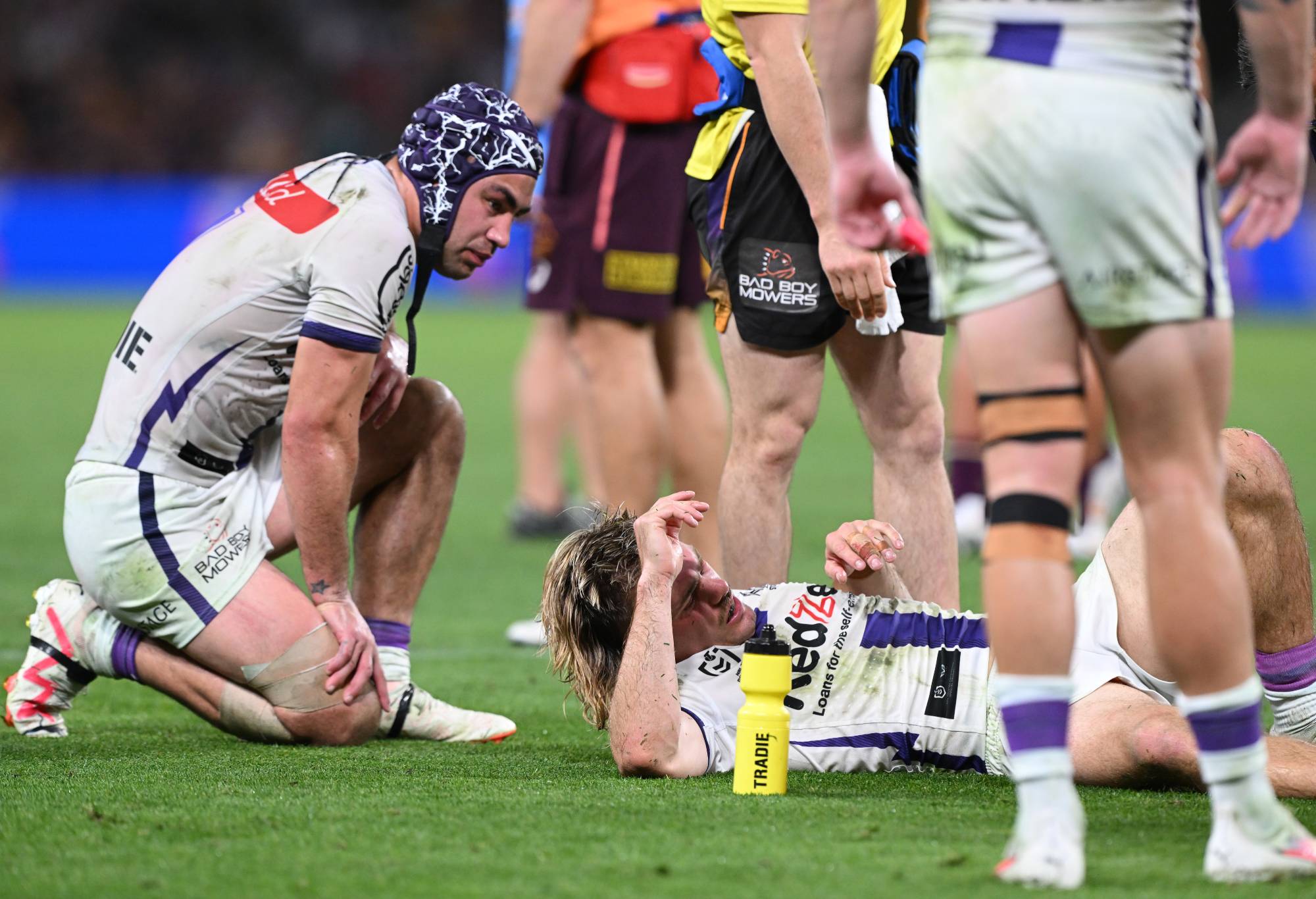 BRISBANE, AUSTRALIA - SEPTEMBER 08: Ryan Papenhuyzen of the Storm is attended to by a team trainer after an ankle injury during the NRL Qualifying Final match between the Brisbane Broncos and Melbourne Storm at Suncorp Stadium on September 08, 2023 in Brisbane, Australia. (Photo by Bradley Kanaris/Getty Images)