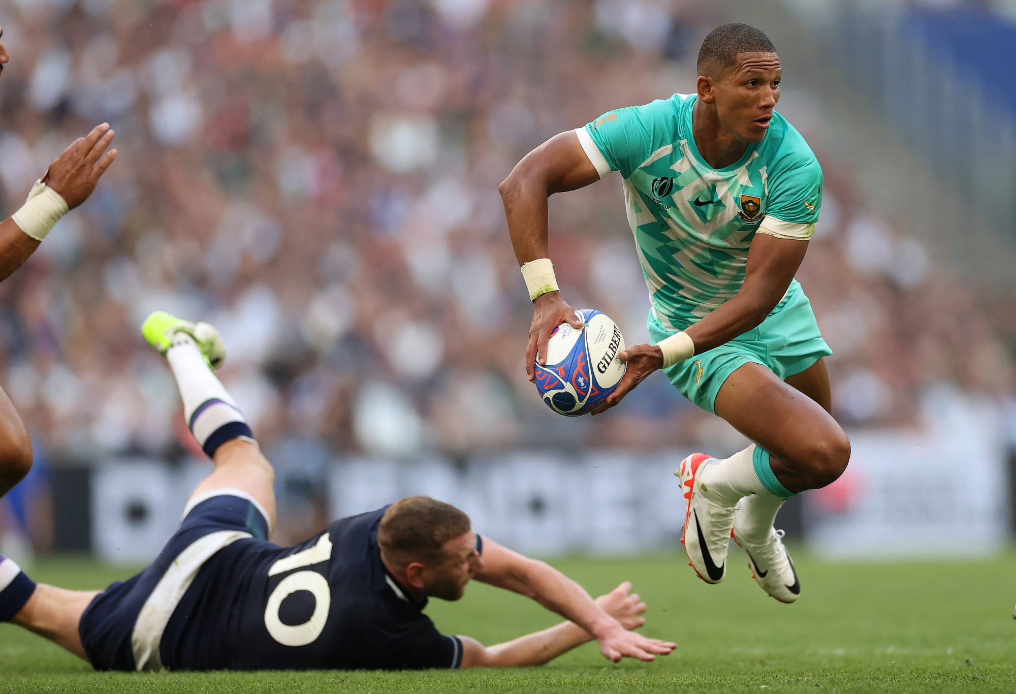 Manie Libbok of South Africa evades the challenge of Scotland's Finn Russell during the Rugby World Cup France 2023 match between South Africa and Scotland at Stade Velodrome on September 10, 2023 in Marseille, France. (Photo by Michael Steele - World Rugby/World Rugby via Getty Images)