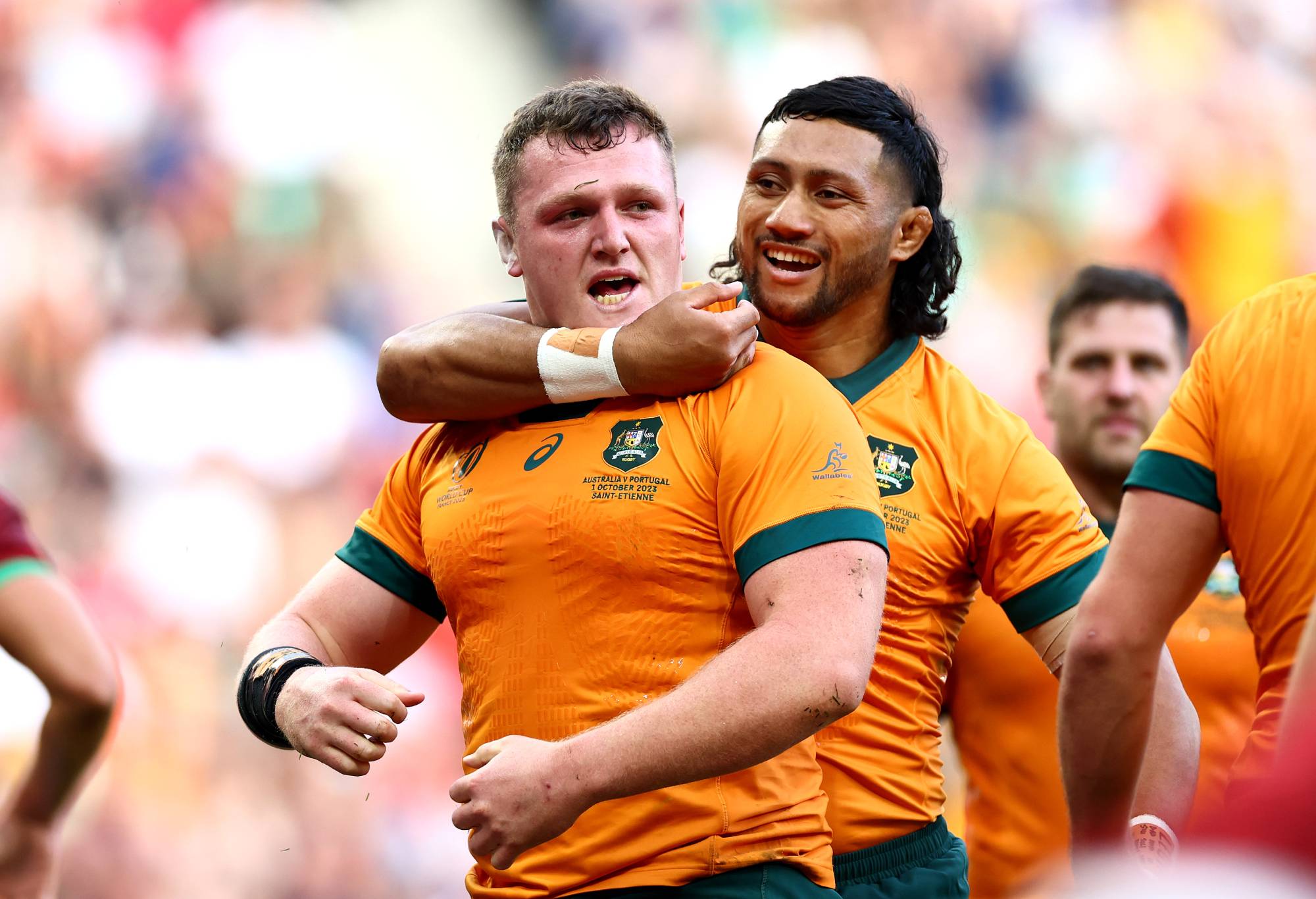 Angus Bell of Australia celebrates with Robert Leota of Australia after scoring his team's third try during the Rugby World Cup France 2023 match between Australia and Portugal at Stade Geoffroy-Guichard on October 01, 2023 in Saint-Etienne, France. (Photo by Chris Hyde/Getty Images)