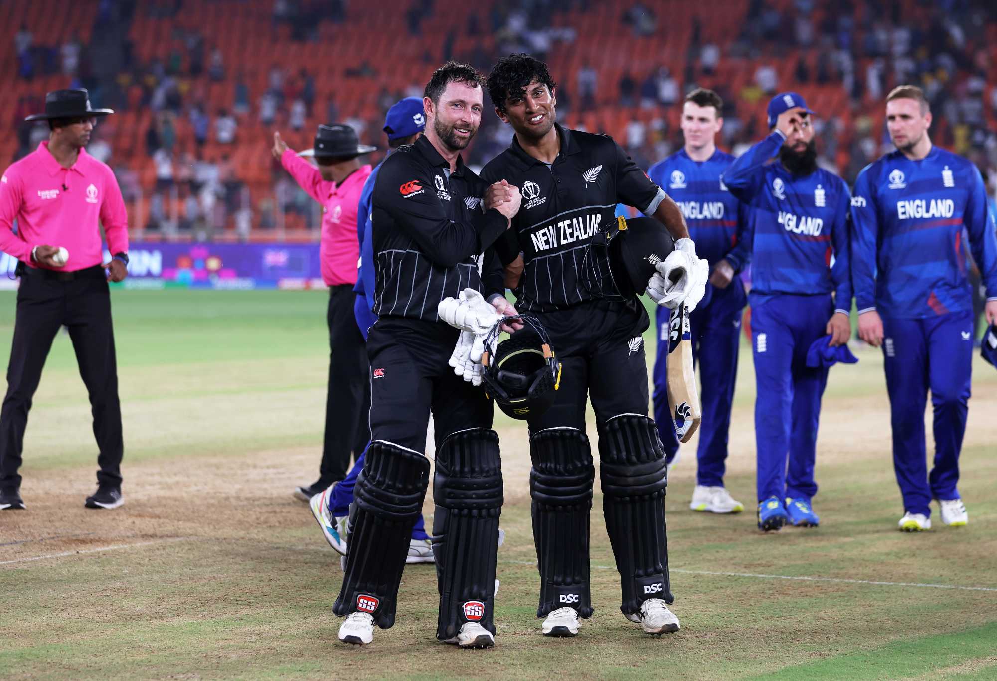 AHMEDABAD, INDIA - OCTOBER 05: Devon Conway and Rachin Ravindra of New Zealand make their way off after an unbeaten 273 partnership following the ICC Men's Cricket World Cup India 2023 between England and New Zealand at Narendra Modi Stadium on October 05, 2023 in Ahmedabad, India. (Photo by Matthew Lewis-ICC/ICC via Getty Images)