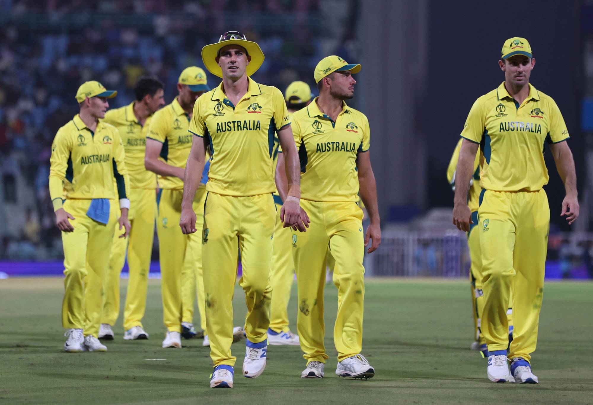 LUCKNOW, INDIA - OCTOBER 12: Pat Cummins of Australia (L) leads their side off at the end of the innings during the ICC Men's Cricket World Cup India 2023 between Australia and South Africa at BRSABVE Cricket Stadium on October 12, 2023 in Lucknow, India. (Photo by Matthew Lewis-ICC/ICC via Getty Images)