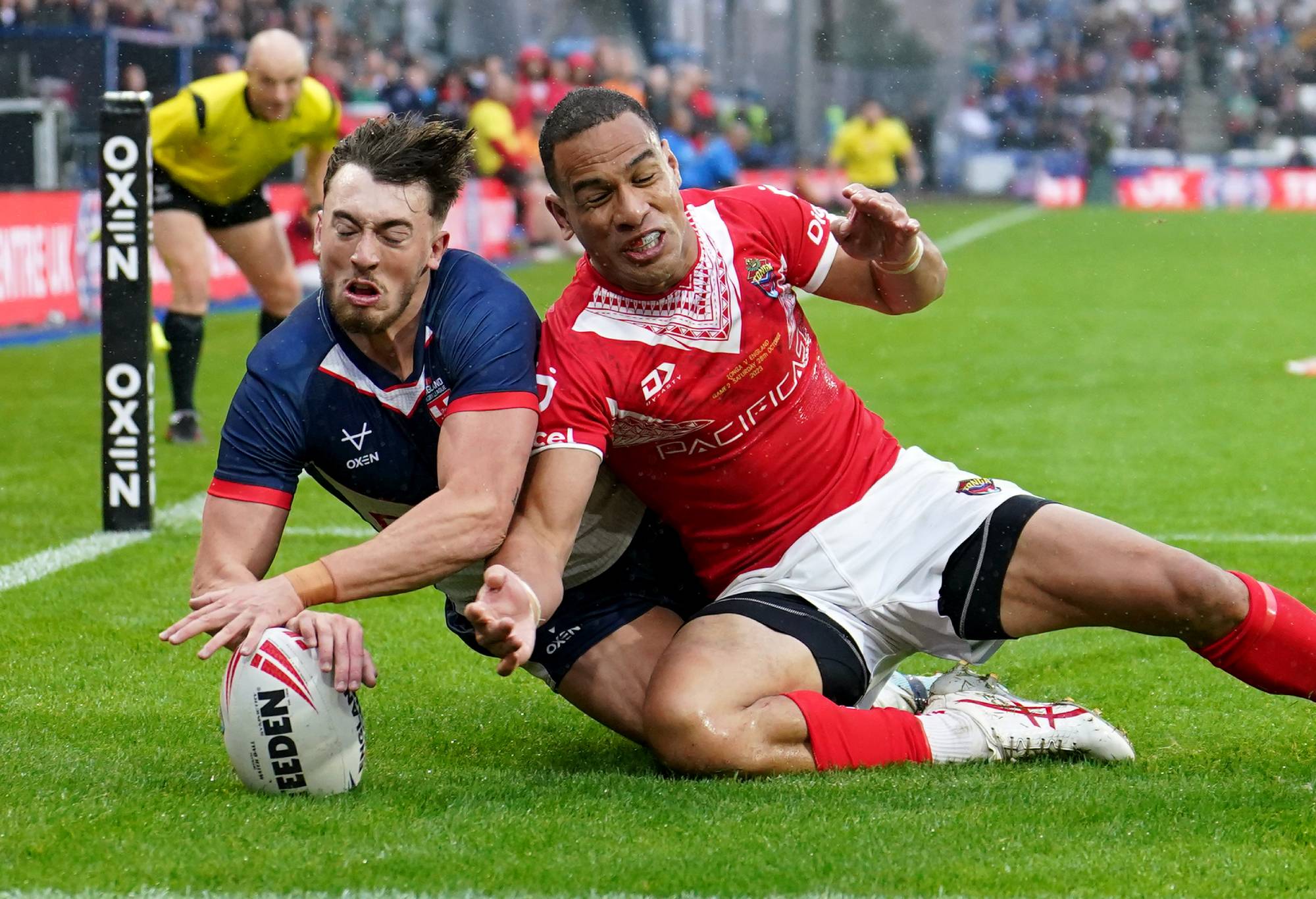 England's Matty Ashton (left) scores his sides second try of the game as Tonga's Will Hopoate (right) is unable to stop him from scoring during the International Test Series match at John Smith's Stadium, Huddersfield. Picture date: Saturday October 28, 2023. (Photo by Martin Rickett/PA Images via Getty Images)