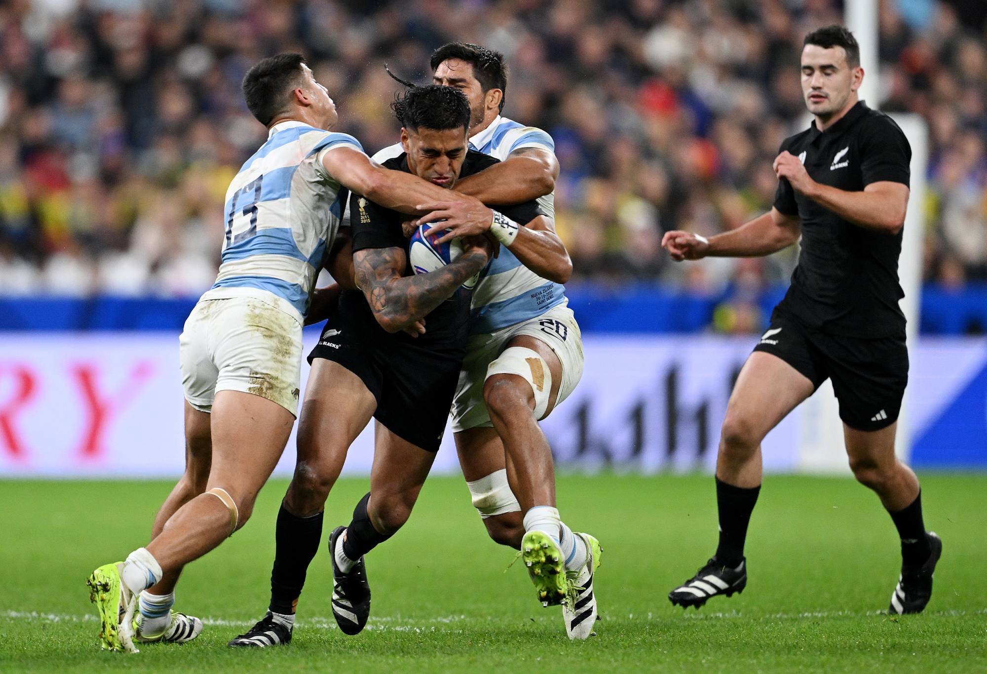 Rieko Ioane of New Zealand is tackled by Lucio Cinti and Rodrigo Bruni of Argentina during the Rugby World Cup France 2023 semi-final match between Argentina and New Zealand at Stade de France on October 20, 2023 in Paris, France. (Photo by Hannah Peters/Getty Images)