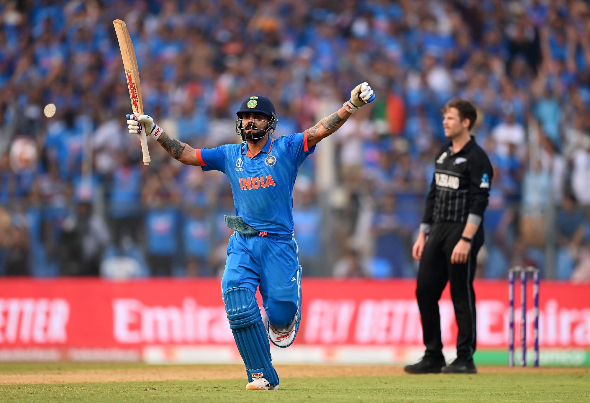 MUMBAI, INDIA - NOVEMBER 15: Virat Kohli of India celebrates after scoring a century, overtaking Sachin Tendulkar for the all time most ODI centuries during the ICC Men's Cricket World Cup India 2023 Semi Final match between India and New Zealand at Wankhede Stadium on November 15, 2023 in Mumbai, India. (Photo by Alex Davidson-ICC/ICC via Getty Images)
