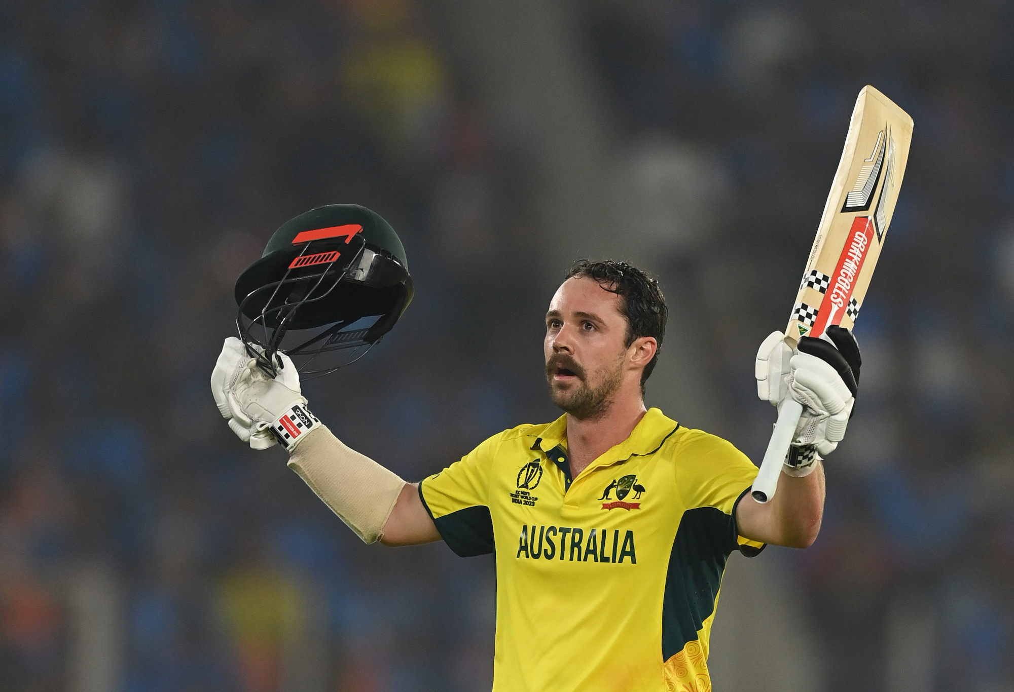 Travis Head celebrates his century during the World Cup final.