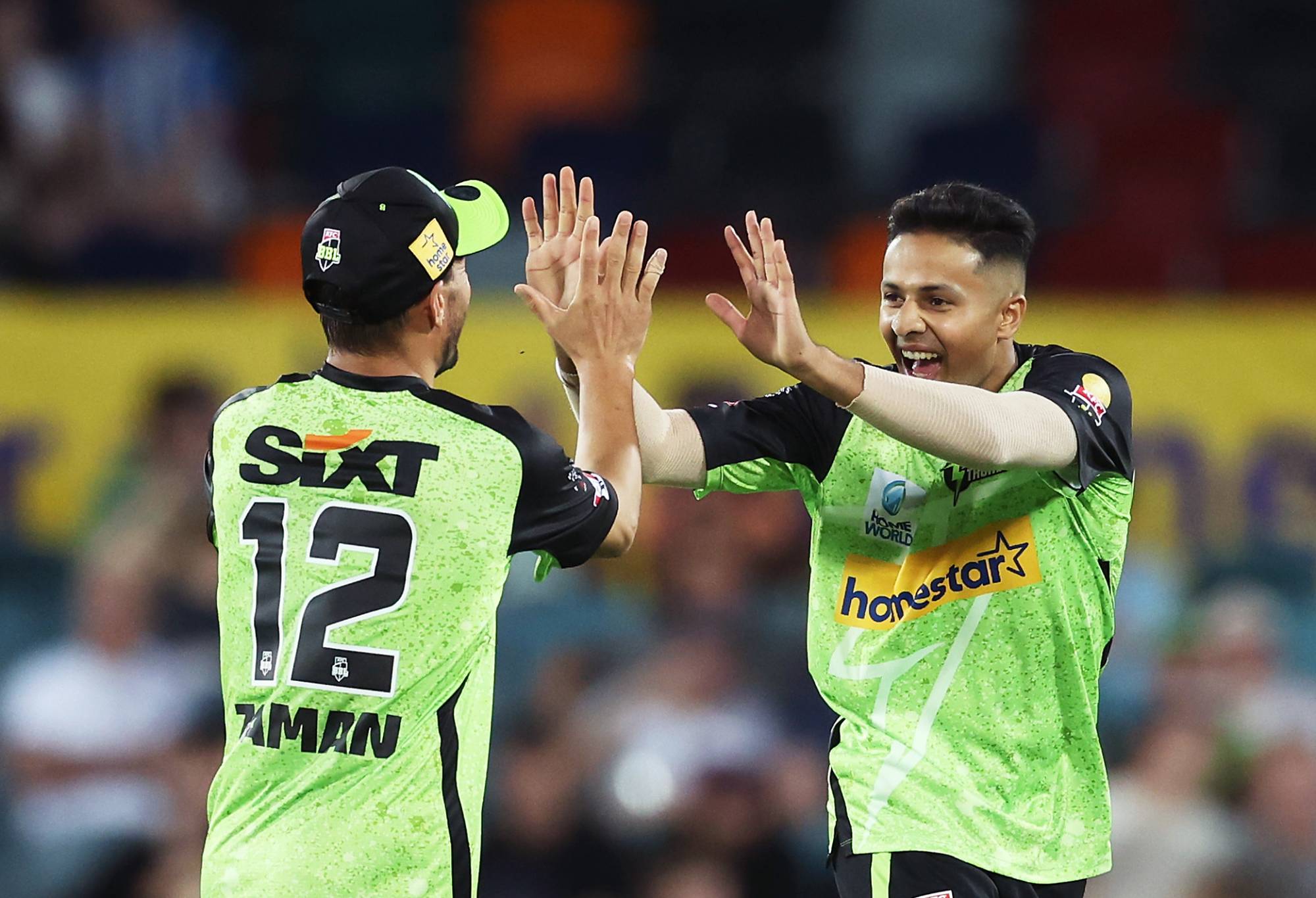 CANBERRA, AUSTRALIA - DECEMBER 12:  Tanveer Sangha of the Thunder celebrates with team mates after taking the wicket of Matt Renshaw of the Heat during the BBL match between Sydney Thunder and Brisbane Heat at Manuka Oval, on December 12, 2023, in Canberra, Australia. (Photo by Matt King/Getty Images)