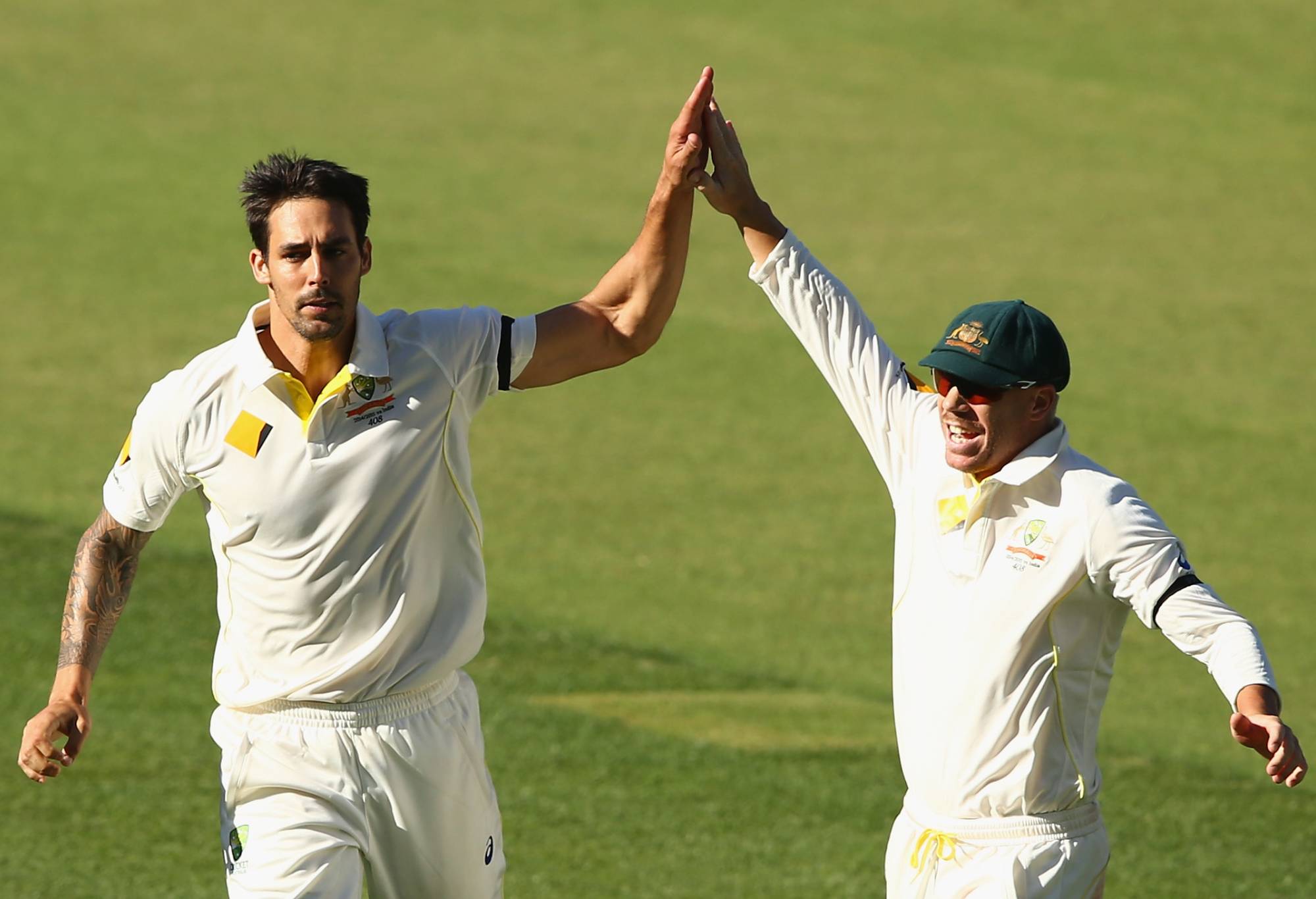ADELAIDE, AUSTRALIA - DECEMBER 11: Mitchell Johnson and David Warner of Australia celebrate the wicket of Virat Kohli of India during day three of the First Test match between Australia and India at Adelaide Oval on December 11, 2014 in Adelaide, Australia. (Photo by Robert Cianflone/Getty Images)