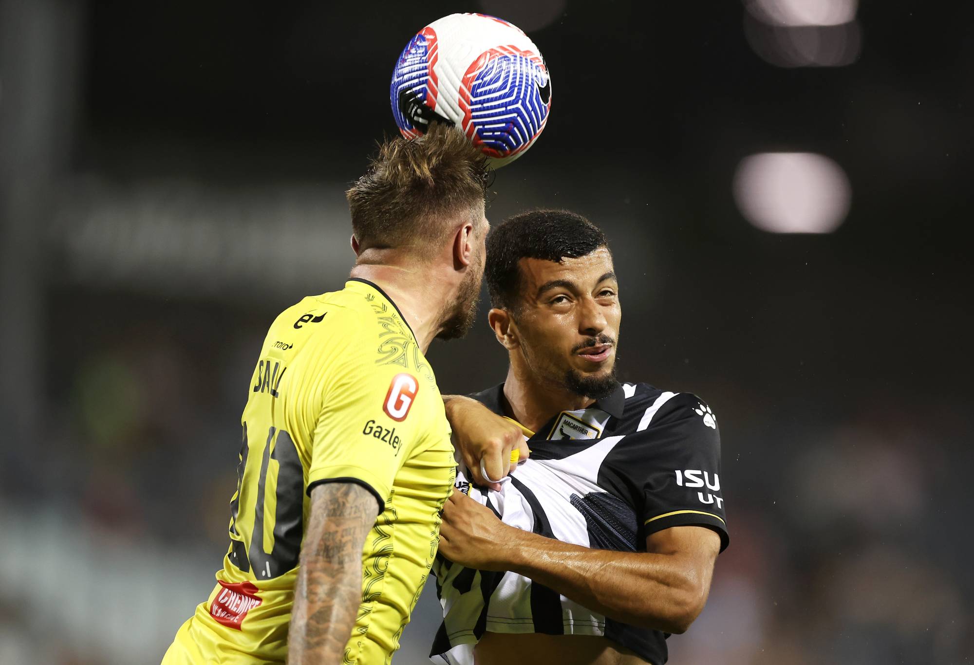 David Ball of the Phoenix and Ali Auglah of the Bulls compete for the ball during the A-League Men round eight match between Macarthur FC and Wellington Phoenix at Campbelltown Stadium, on December 18, 2023, in Sydney, Australia. (Photo by Mark Kolbe/Getty Images)