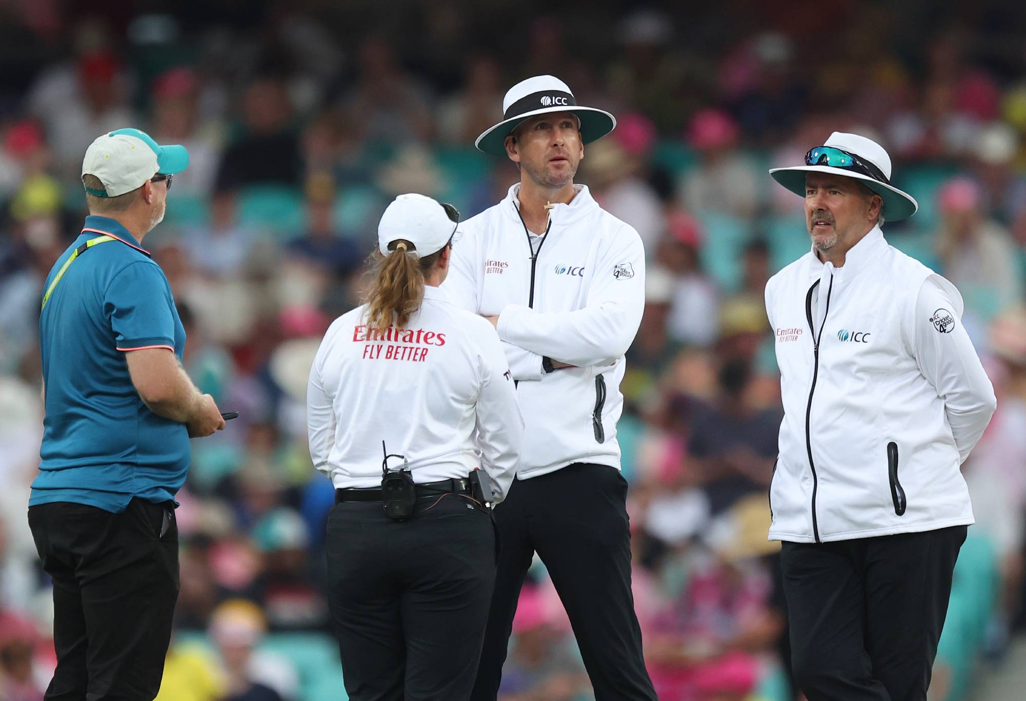 SYDNEY, AUSTRALIA - JANUARY 04: Umpires Michael Gough and Richard Illingworth speak with Reserve Umpire Claire Polosak as play is delayed to due light conditions during day two of the Men's Third Test Match in the series between Australia and Pakistan at Sydney Cricket Ground on January 04, 2024 in Sydney, Australia. (Photo by Mike Owen - CA/Cricket Australia via Getty Images)
