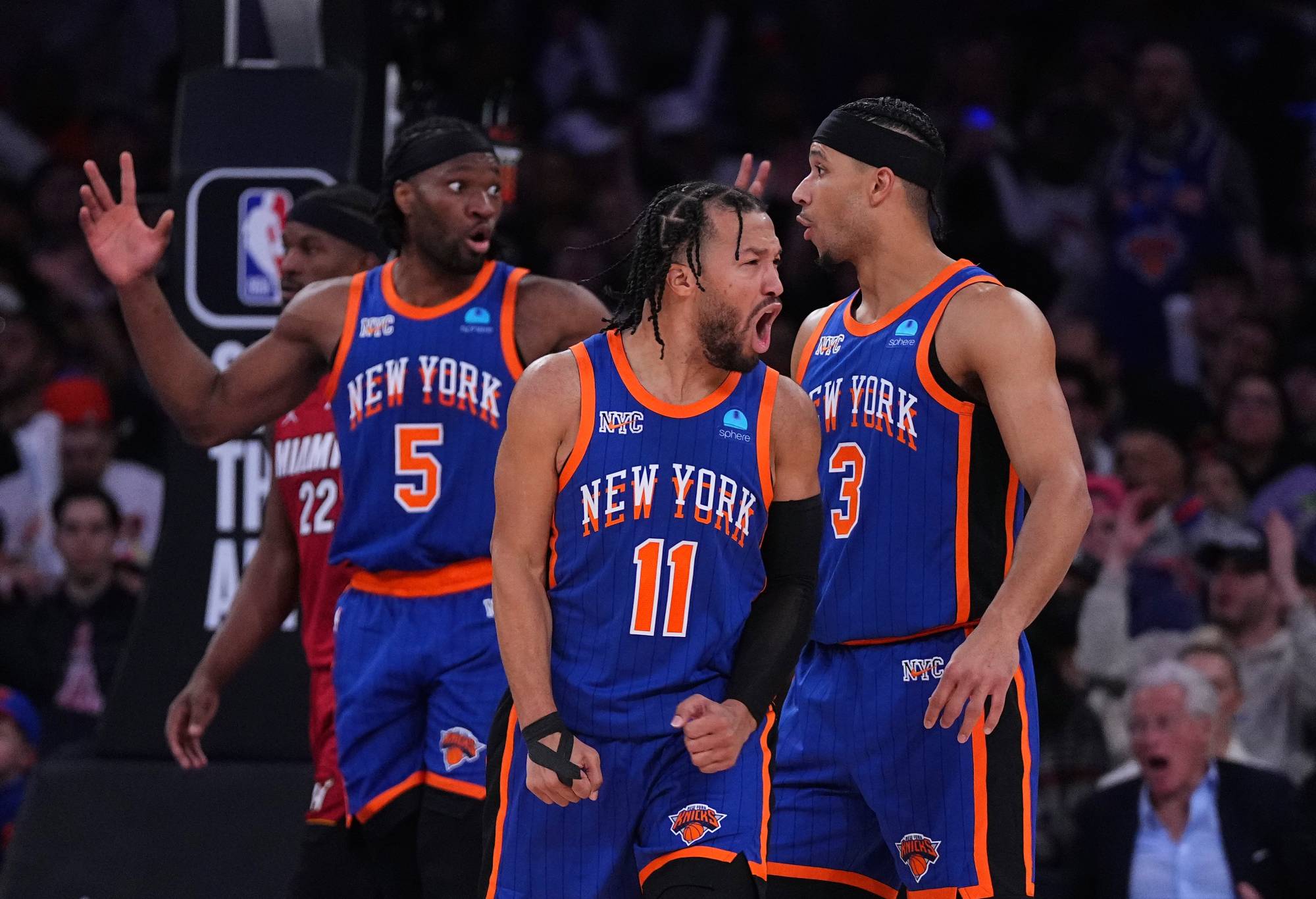 NEW YORK, NEW YORK - JANUARY 27: (L-R) Precious Achiuwa #5, Jalen Brunson #11 and Josh Hart #3 of the New York Knicks react against the Miami Heat in the second half at Madison Square Garden on January 27, 2024 in New York City. The Knicks defeated the Heat 125-109. NOTE TO USER: User expressly acknowledges and agrees that, by downloading and or using this photograph, User is consenting to the terms and conditions of the Getty Images License Agreement. (Photo by Mitchell Leff/Getty Images)