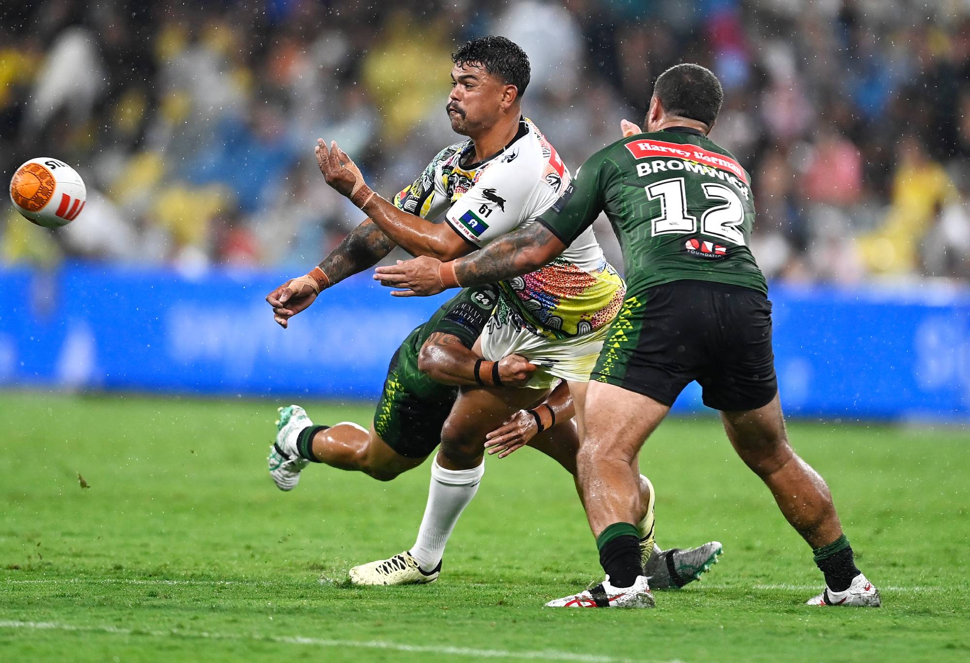 TOWNSVILLE, AUSTRALIA - FEBRUARY 16: Latrell Mitchell of the Indigenous All-Stars passes as he is tackled during the NRL All-Stars match between Men's Australia Indigenous All Stars and Aotearoa NZ Men's Maori Tane at Queensland Country Bank Stadium on February 16, 2024 in Townsville, Australia. (Photo by Ian Hitchcock/Getty Images)