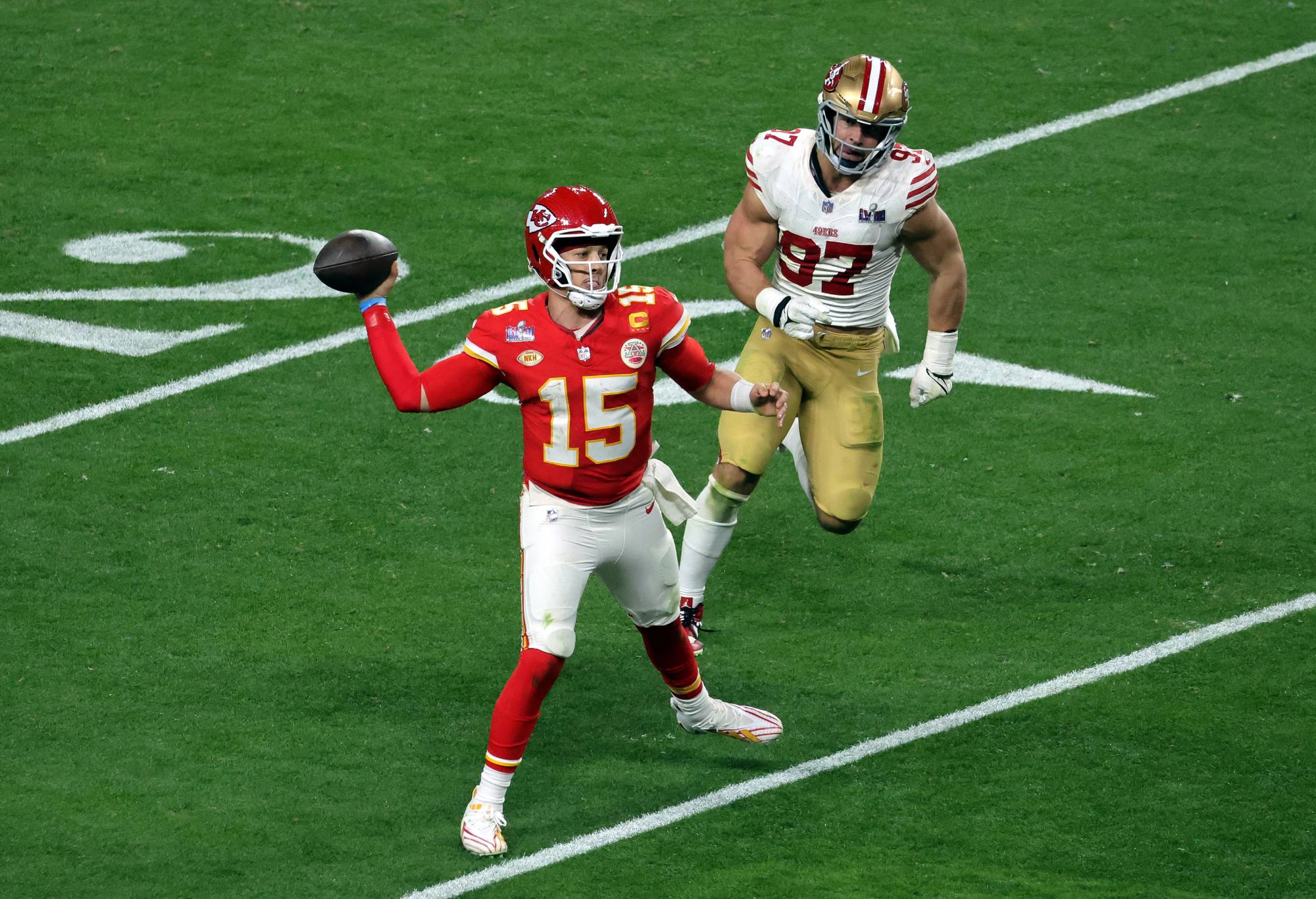 : Patrick Mahomes #15 of the Kansas City Chiefs looks to pass in the fourth quarter against Nick Bosa #97 of the San Francisco 49ers during Super Bowl LVIII at Allegiant Stadium on February 11, 2024 in Las Vegas, Nevada. (Photo by Ethan Miller/Getty Images)