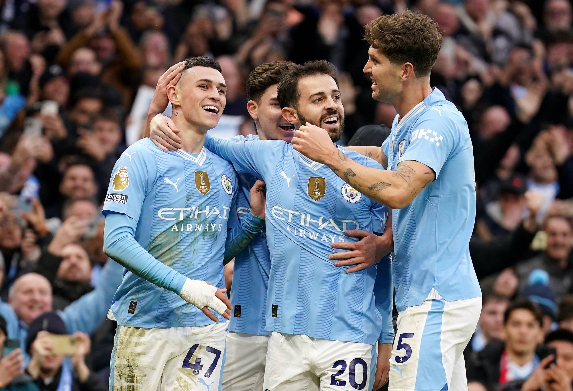 Manchester City's Phil Foden celebrates with team-mates after scoring their side's second goal of the game during the Premier League match at the Etihad Stadium, Manchester. Picture date: Sunday March 3, 2024. (Photo by Mike Egerton/PA Images via Getty Images)