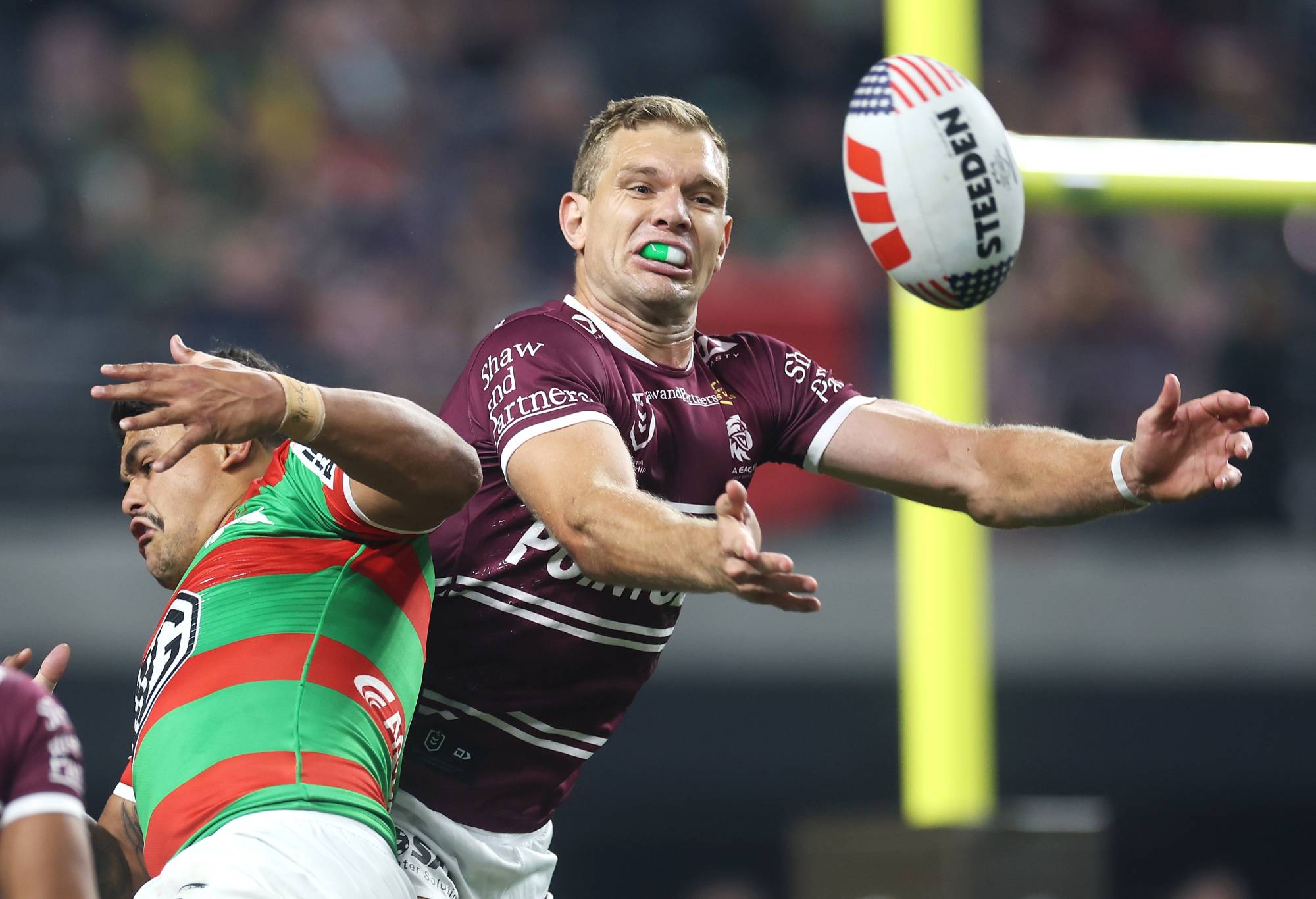 LAS VEGAS, NEVADA - MARCH 02: Latrell Mitchell of the Rabbitohs and Tom Trbojevic of the Sea Eagles compete for the ball from a kick during the round one NRL match between Manly Sea Eagles and South Sydney Rabbitohs at Allegiant Stadium, on March 02, 2024, in Las Vegas, Nevada. (Photo by Ezra Shaw/Getty Images)