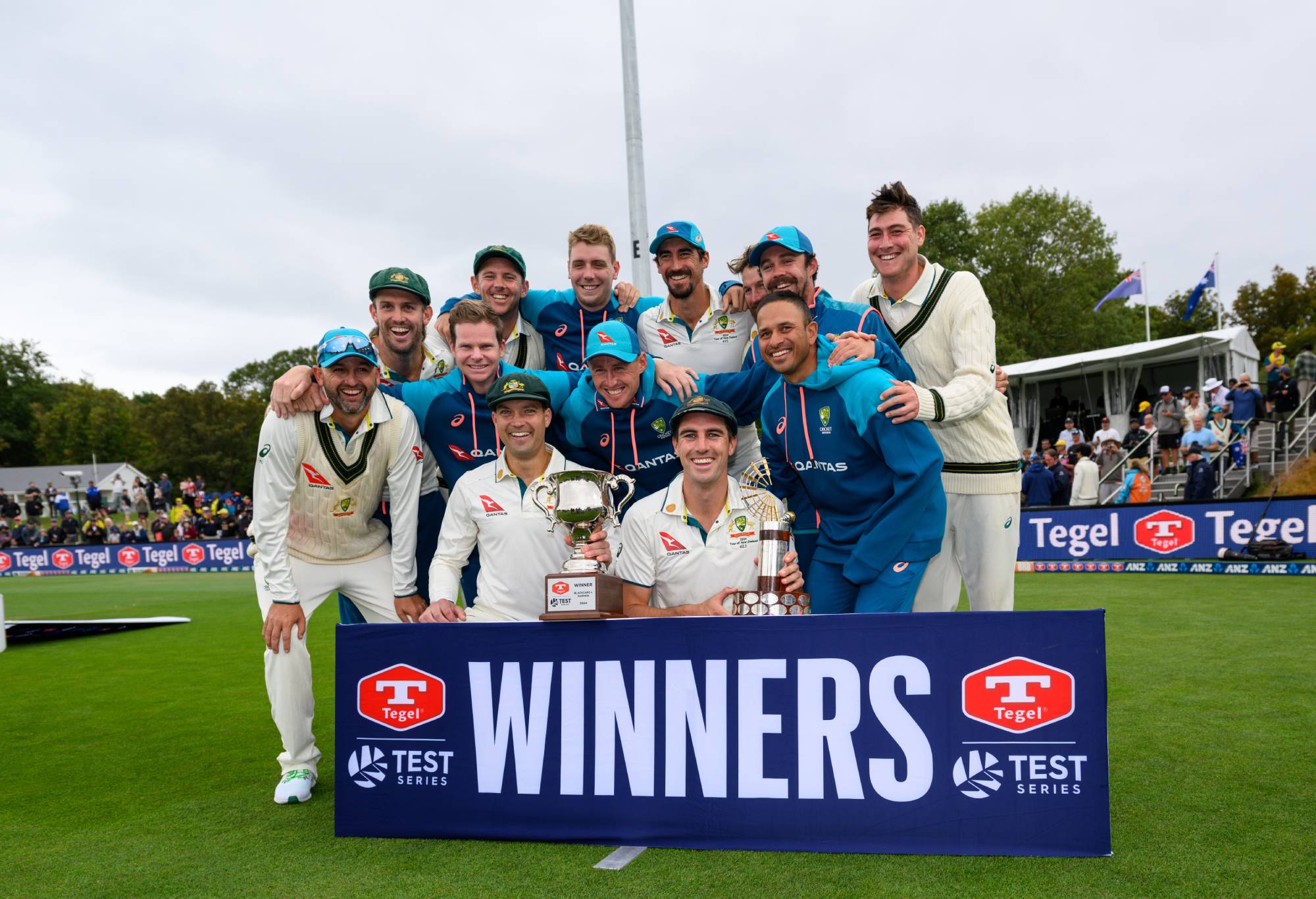 CHRISTCHURCH, NEW ZEALAND - MARCH 11: Captain Pat Cummins of Australia (C) and his team mates pose with the trophy after their series win during day four of the Second Test in the series between New Zealand and Australia at Hagley Oval on March 11, 2024 in Christchurch, New Zealand. (Photo by Kai Schwoerer/Getty Images)