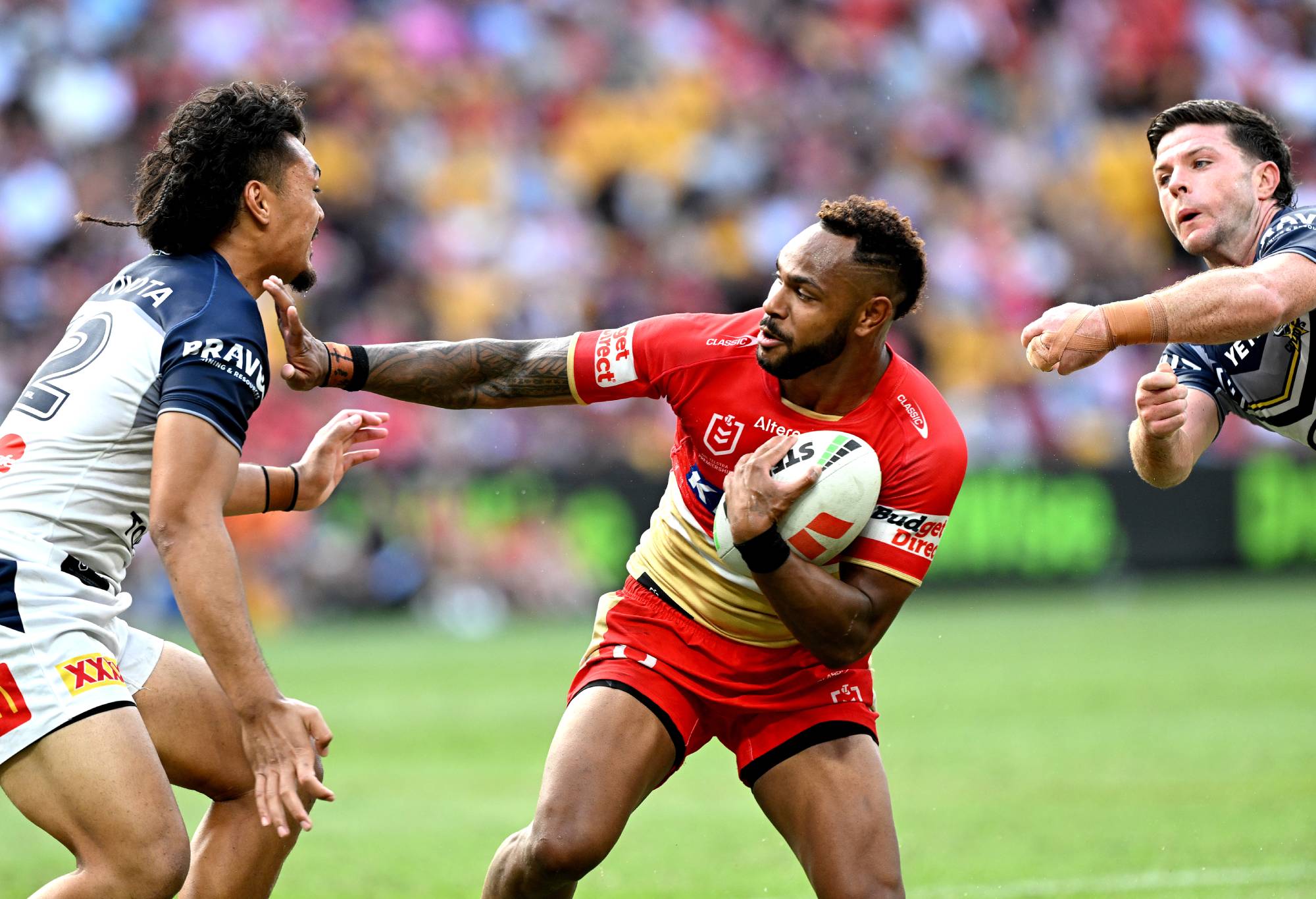 BRISBANE, AUSTRALIA - MARCH 10: Hamiso Tabuai-Fidow of the Dolphins pushes away the defence during the round one NRL match between the Dolphins and North Queensland Cowboys at Suncorp Stadium, on March 10, 2024, in Brisbane, Australia. (Photo by Bradley Kanaris/Getty Images)