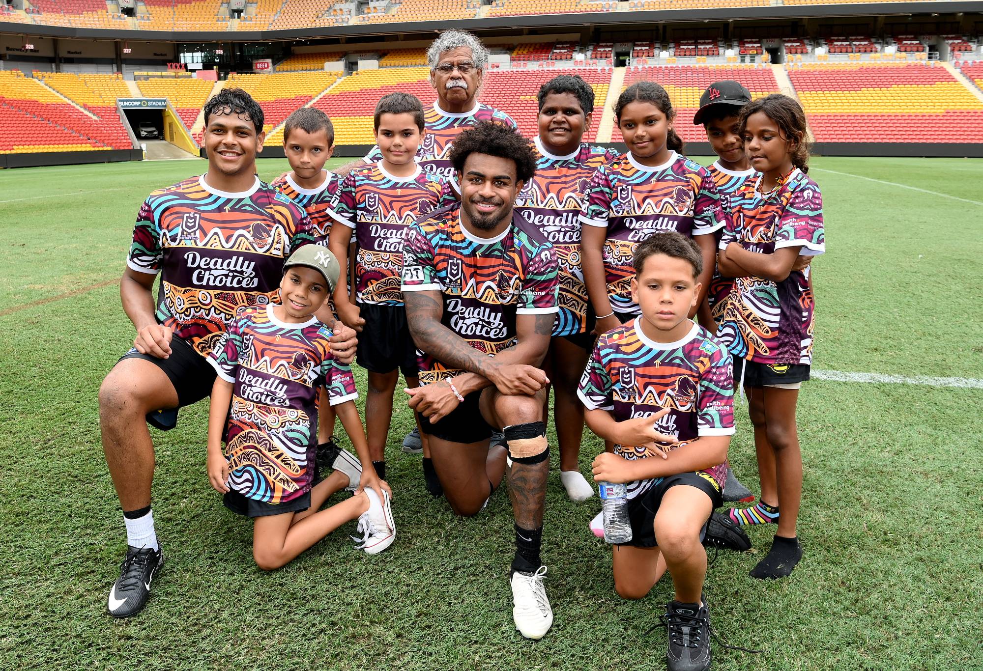 Broncos players Ezra Mam and Selwyn Cobbo with a group of young Indigenous kids after a Brisbane Broncos NRL training session at Suncorp Stadium on Monday. (Photo by Bradley Kanaris/Getty Images)