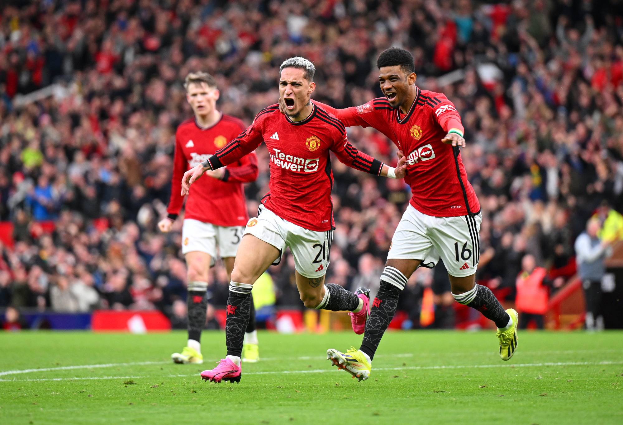 MANCHESTER, ENGLAND - MARCH 17: Antony of Manchester United celebrates scoring his team's second goal with teammate Amad Diallo during the Emirates FA Cup Quarter Final between Manchester United and Liverpool FC at Old Trafford on March 17, 2024 in Manchester, England. (Photo by Michael Regan/Getty Images)