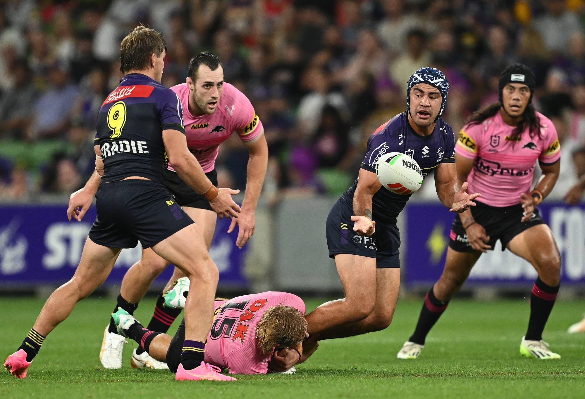 MELBOURNE, AUSTRALIA - MARCH 08: Jahrome Hughes of the Storm passes the ball during the round one NRL match between Melbourne Storm and Penrith Panthers at AAMI Park on March 08, 2024, in Melbourne, Australia.