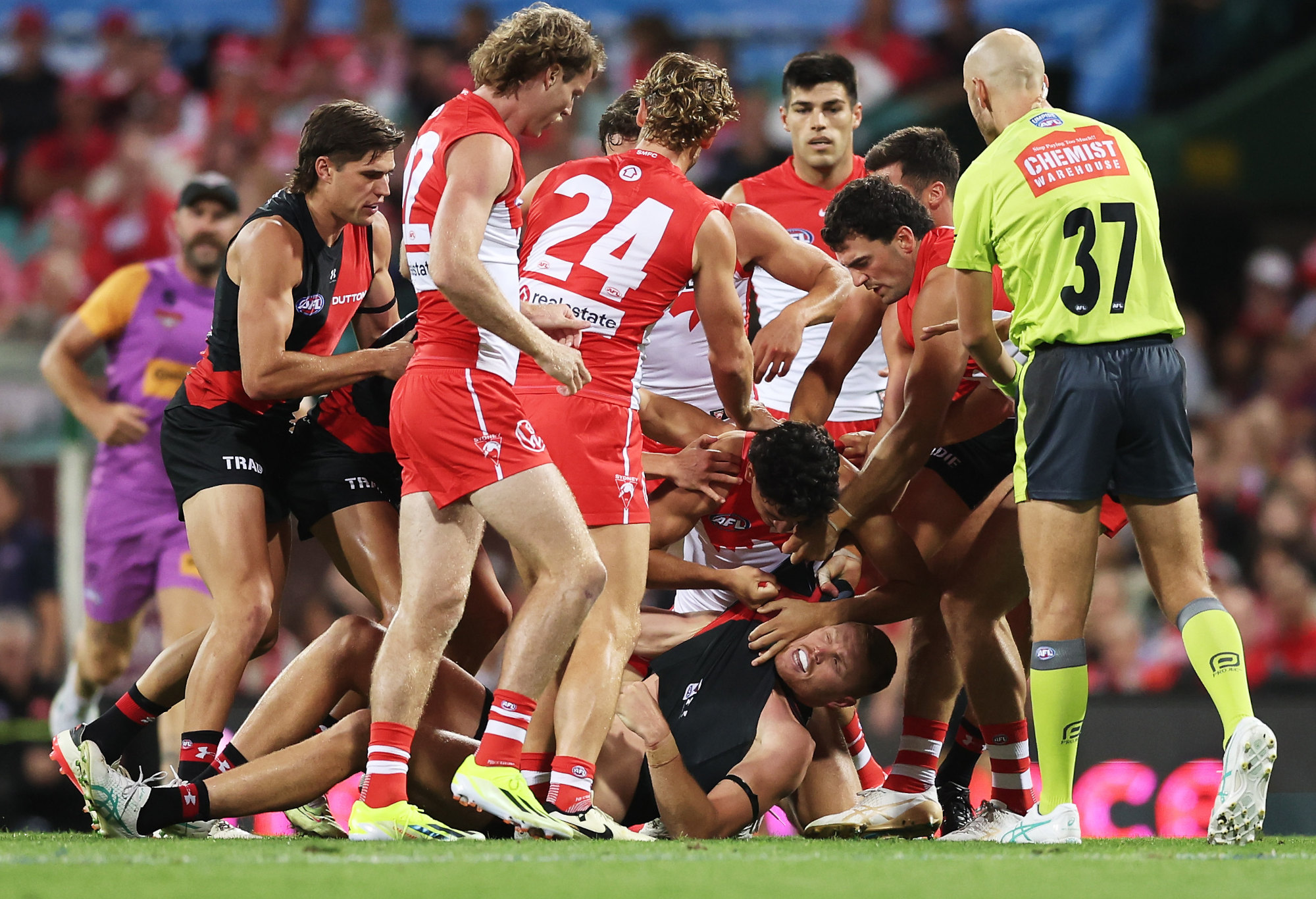 Sydney players wrestle with Peter Wright.
