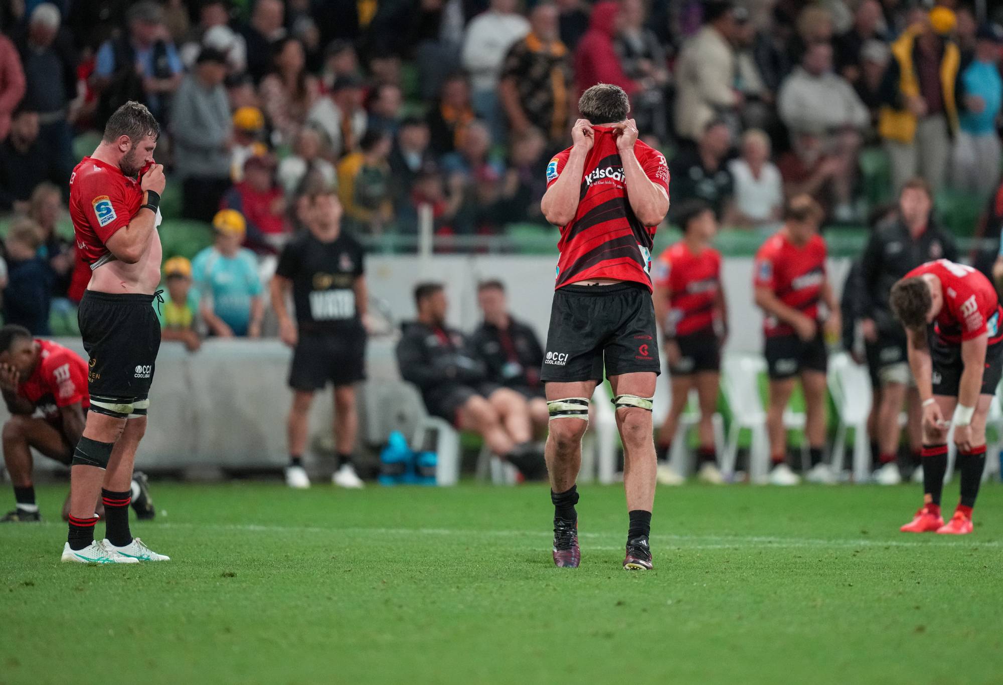Scott Barrett of the Crusaders (centre) and Crusaders players react after defeat at the final whistle during the round two Super Rugby Pacific match between Crusaders and NSW Waratahs at AAMI Park, on March 02, 2024, in Melbourne, Australia. (Photo by Asanka Ratnayake/Getty Images)