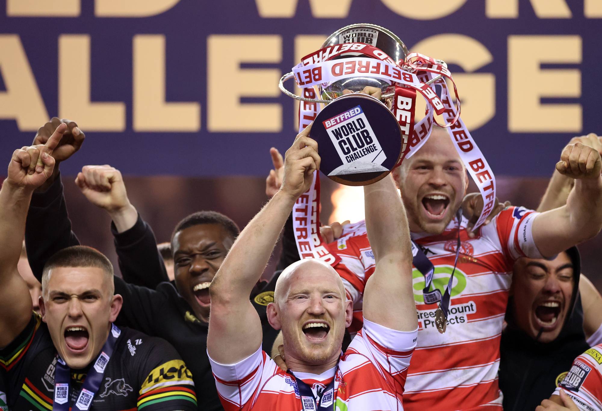 Liam Farrell of Wigan Warriors lift the trophy following victory during the Betfred Super League Final match between Wigan Warriors v Catalans Dragons at DW Stadium on February 24, 2024 in Wigan, England. (Photo by Jan Kruger/Getty Images)
