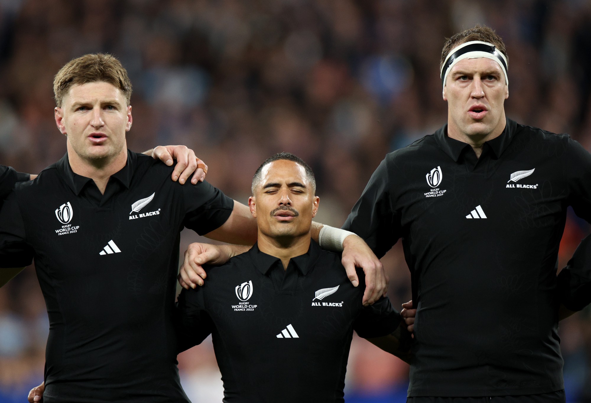 Jordie Barrett, Aaron Smith and Brodie Retallick of New Zealand sing their national anthem prior to the Rugby World Cup France 2023 semi-final match between Argentina and New Zealand at Stade de France on October 20, 2023 in Paris, France. (Photo by Adam Pretty - World Rugby/World Rugby via Getty Images)