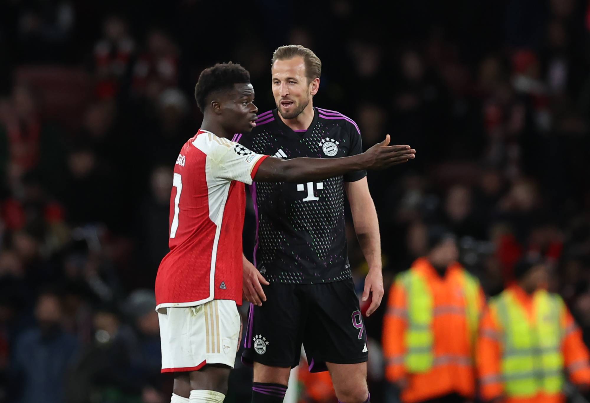 Harry Kane of Bayern Munich speaks with Bukayo Saka of Arsenal at the end of the UEFA Champions League quarter-final first leg match between Arsenal FC and FC Bayern Munchen at Emirates Stadium on April 9, 2024 in London, England.(Photo by Catherine Ivill - AMA/Getty Images)