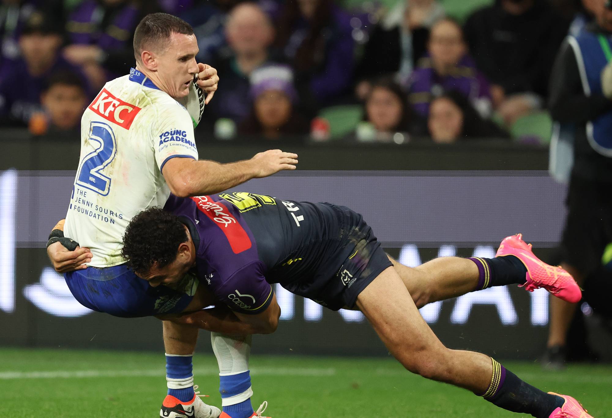 MELBOURNE, AUSTRALIA - APRIL 12: Connor Tracey of the Bulldogs is challenged by Xavier Coates of the Storm during the round six NRL match between Melbourne Storm and Canterbury Bulldogs at AAMI Park, on April 12, 2024, in Melbourne, Australia.