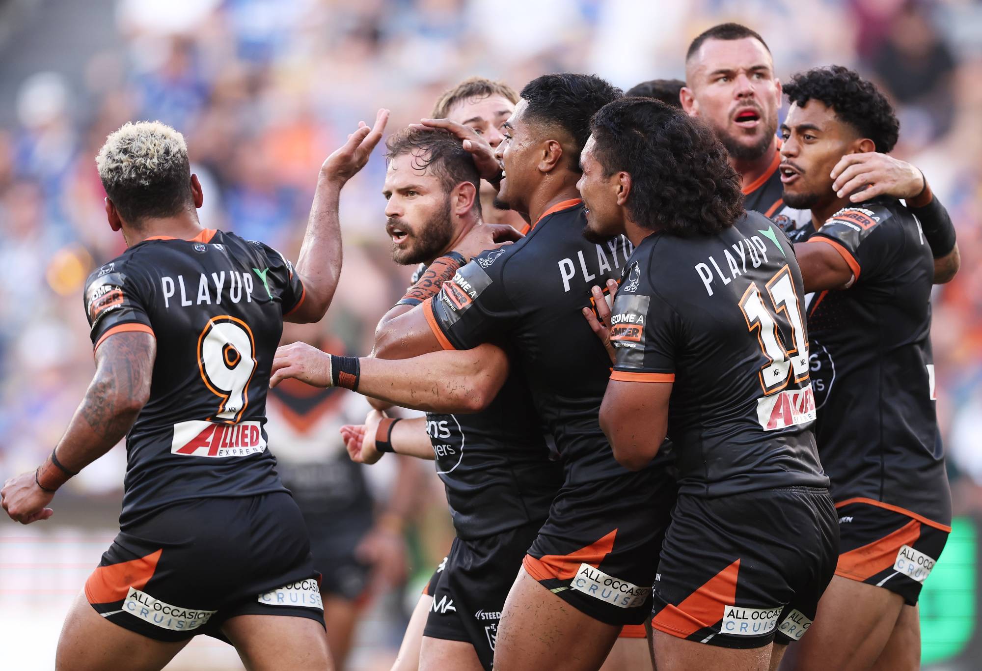 SYDNEY, AUSTRALIA - APRIL 01: Aidan Sezer of the Tigers celebrates with team mates after kicking a field goal during the round four NRL match between Parramatta Eels and Wests Tigers at CommBank Stadium, on April 01, 2024, in Sydney, Australia. (Photo by Matt King/Getty Images)