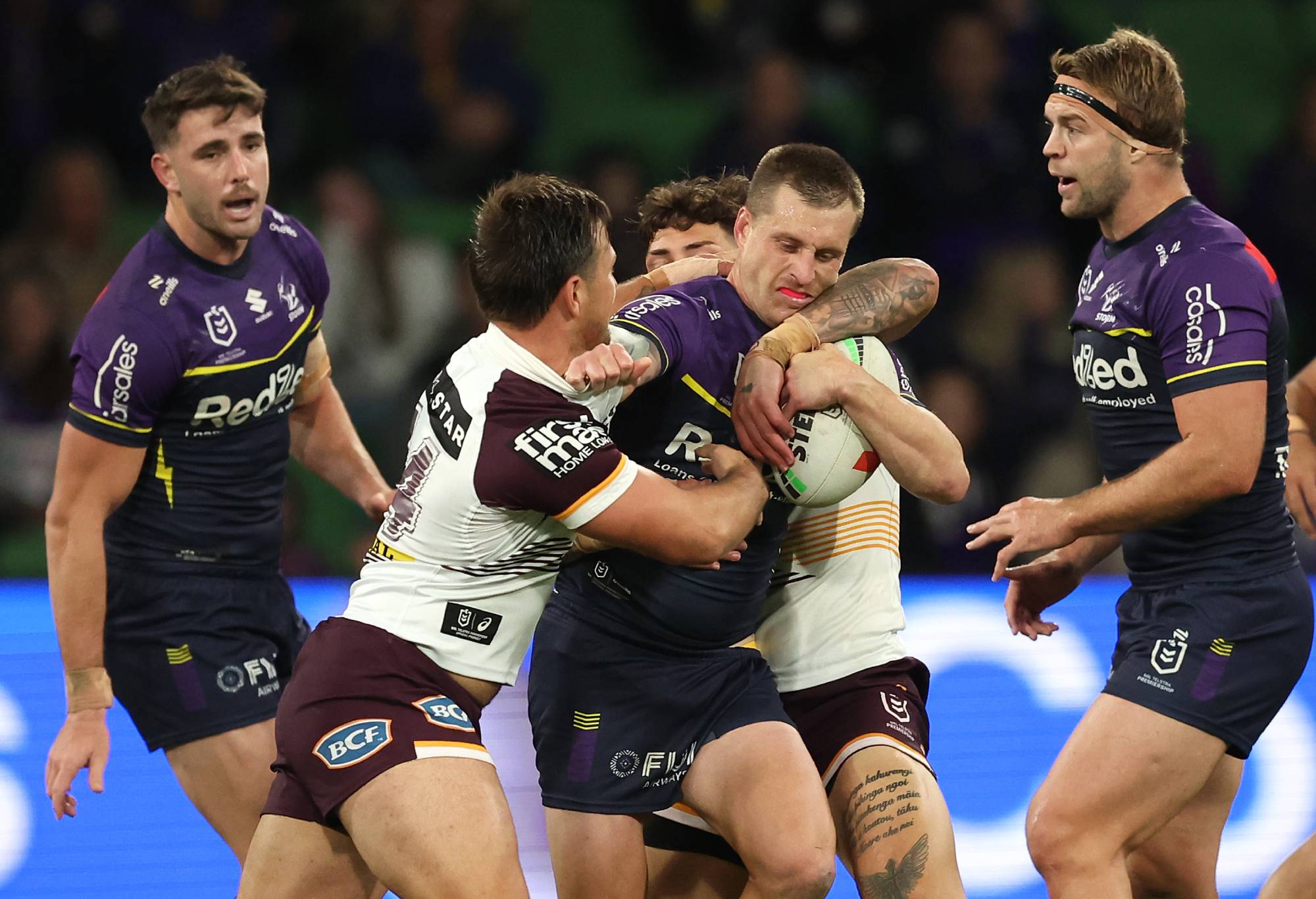 MELBOURNE, AUSTRALIA - APRIL 04: Cameron Munster of the Storm is tackled during the round five NRL match between Melbourne Storm and Brisbane Broncos at AAMI Park on April 04, 2024, in Melbourne, Australia. (Photo by Robert Cianflone/Getty Images)