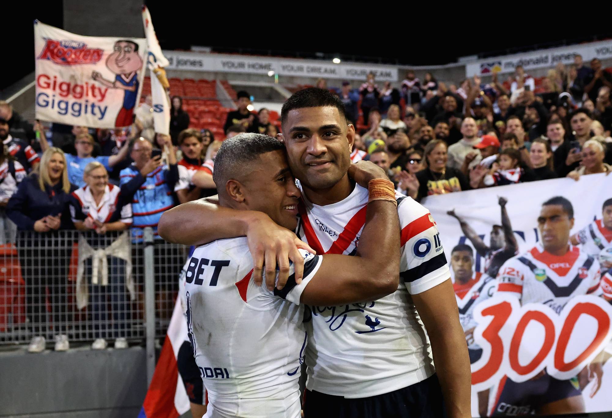 NEWCASTLE, AUSTRALIA - APRIL 11: Michael Jennings of the Roosters celebrates playing 300 games with Daniel Tupou of the Roosters after winning the round six NRL match between Newcastle Knights and Sydney Roosters at McDonald Jones Stadium, on April 11, 2024, in Newcastle, Australia. (Photo by Cameron Spencer/Getty Images)