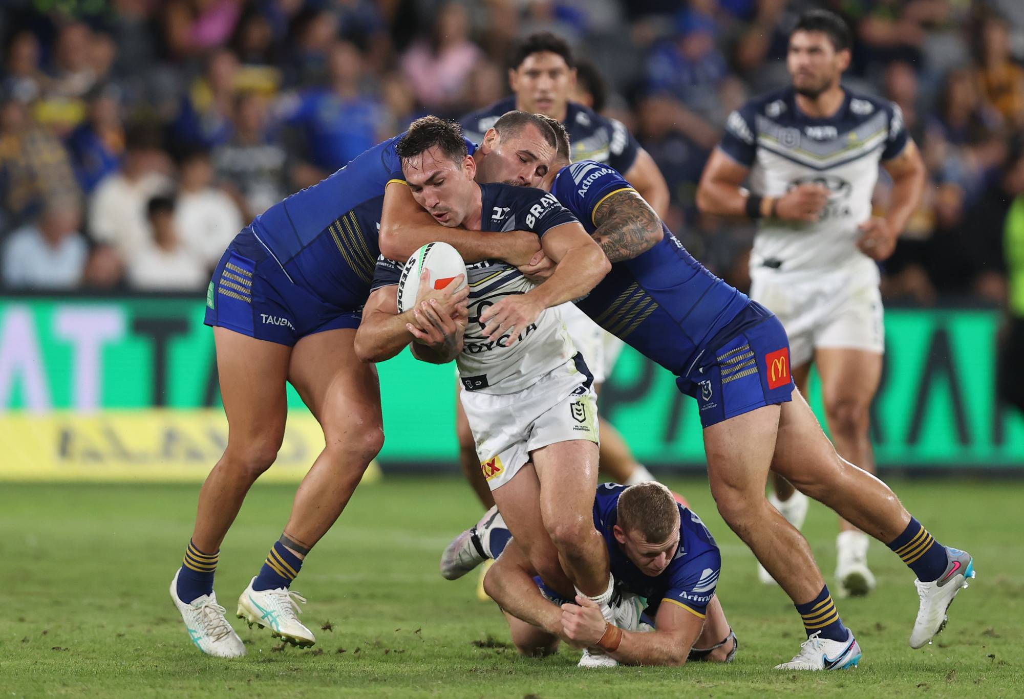 SYDNEY, AUSTRALIA - APRIL 13: Reece Robson of the Cowboys is tackled by Reagan Campbell-Gillard of the Eels during the round six NRL match between Parramatta Eels and North Queensland Cowboys at CommBank Stadium on April 13, 2024 in Sydney, Australia. (Photo by Jason McCawley/Getty Images)
