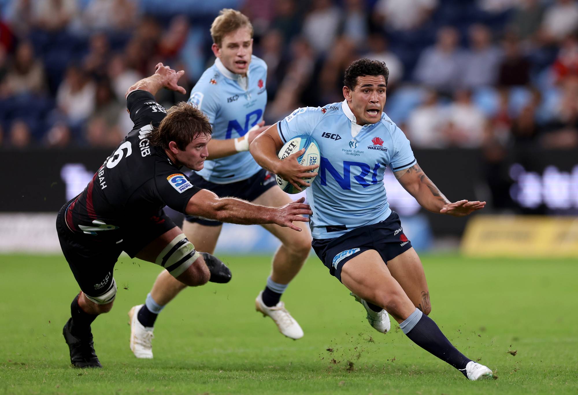 Izaia Perese of the NSW Waratahs is tackled by Ethan Blackadder of the Crusaders during the round eight Super Rugby Pacific match between NSW Waratahs and Crusaders at Allianz Stadium, on April 12, 2024, in Sydney, Australia. (Photo by Cameron Spencer/Getty Images)