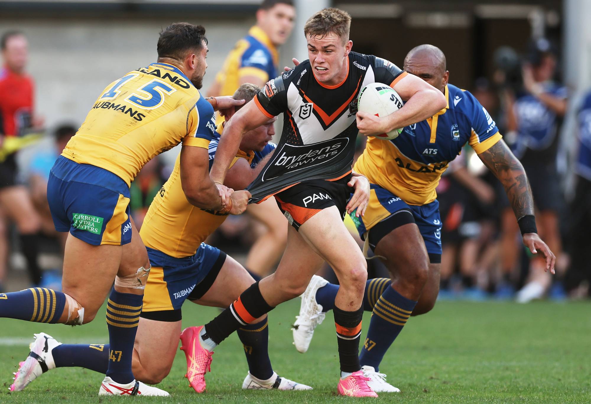 SYDNEY, AUSTRALIA - APRIL 01: Lachlan Galvin of the Tigers is tackled during the round four NRL match between Parramatta Eels and Wests Tigers at CommBank Stadium, on April 01, 2024, in Sydney, Australia.