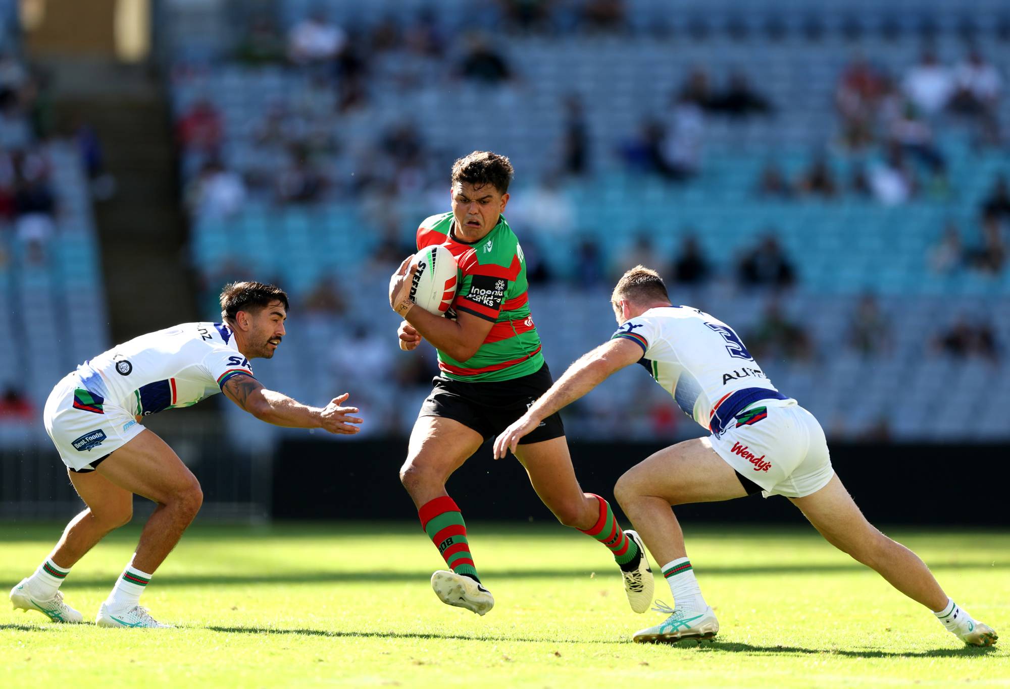 SYDNEY, AUSTRALIA - APRIL 06: Latrell Mitchell of the Rabbitohs is tackled during the round five NRL match between South Sydney Rabbitohs and New Zealand Warriors at Accor Stadium, on April 06, 2024, in Sydney, Australia.