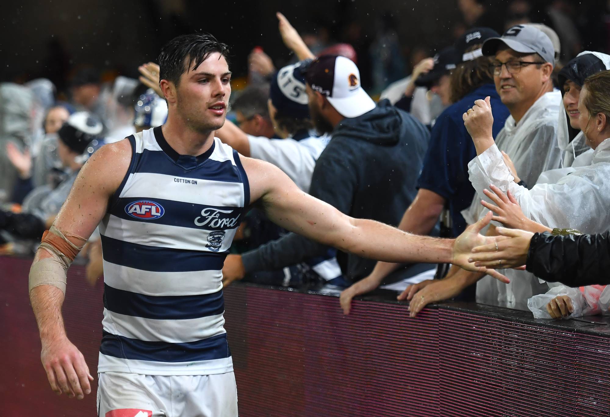  Oliver Henry of the Cats celebrates with fans during the round nine AFL match between Brisbane Lions and Geelong Cats at The Gabba, on April 20, 2024, in Brisbane, Australia. (Photo by Albert Perez/AFL Photos via Getty Images)